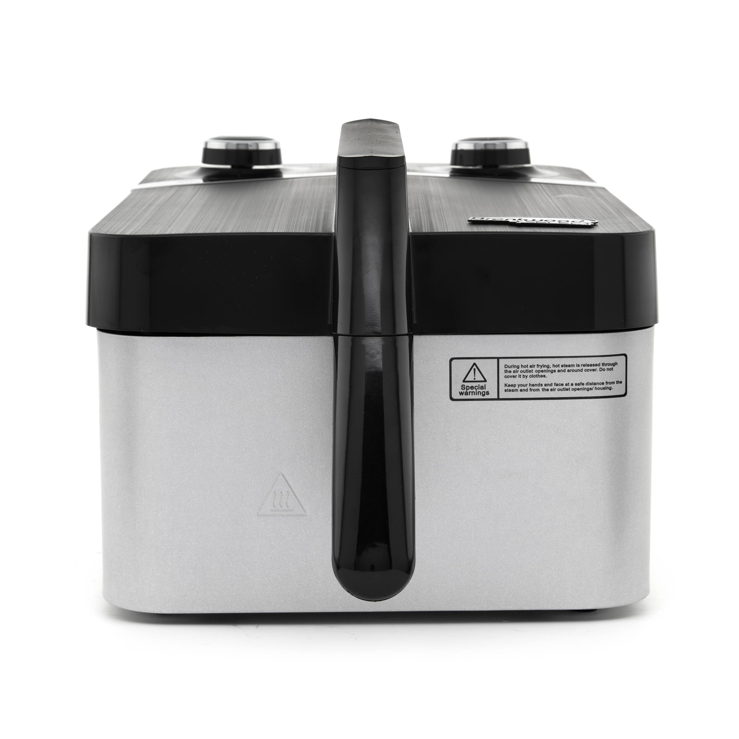 The image features a silver and black appliance, likely a food processor or blender, with a black handle. The appliance has a warning label on it, indicating that it is not to be used with wet hands. The label also provides instructions on how to use the appliance safely. The appliance is sitting on a white background, making it the main focus of the image.