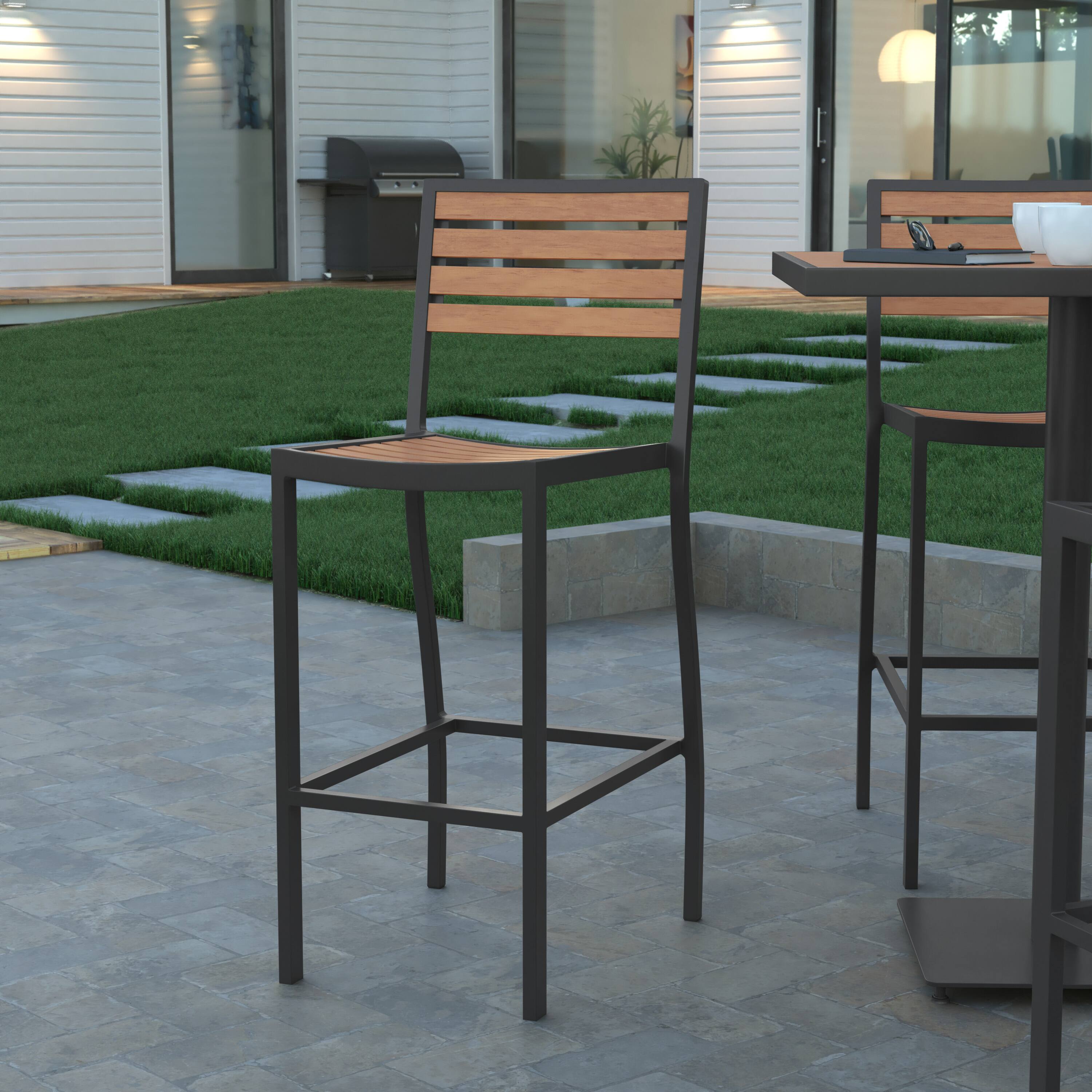 Alt View 1. Emma + Oliver - Livia All-Weather Armless Bar Height Dining Stool with Polyresin Slats and Aluminum Frame - Teak.
