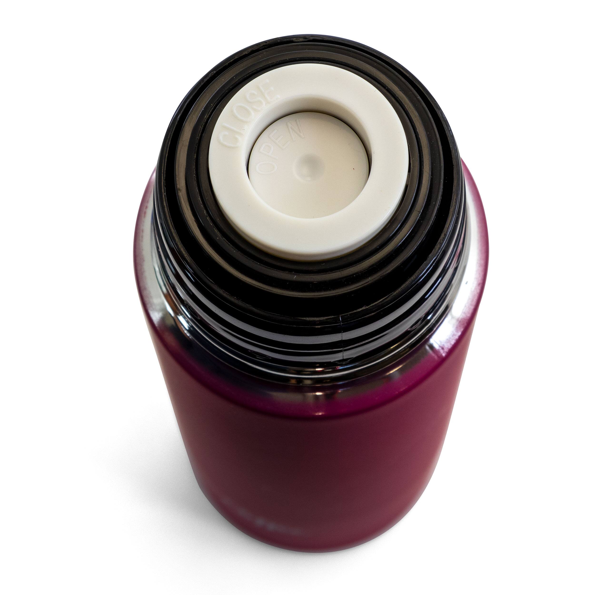 The image shows a purple bottle with a white cap on it. The cap has a hole in the center, which is likely used for pouring or dispensing the contents of the bottle. The bottle is placed on a white background, making it stand out prominently.