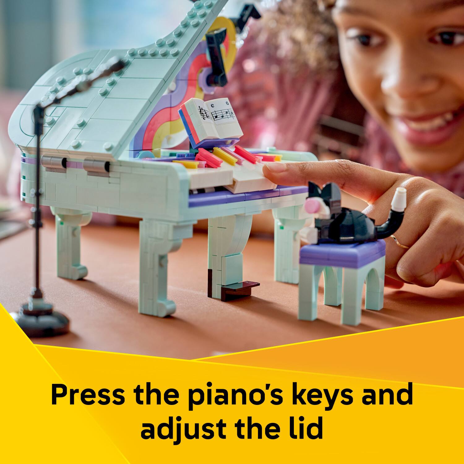 Press the piano's keys and adjust the lid
