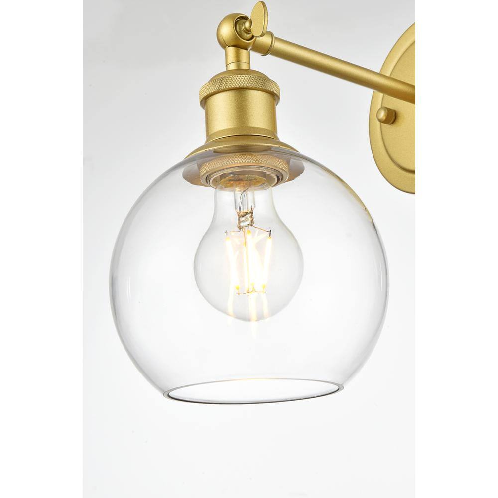 Left. Living District - Kai 1 light Brass and Clear Bath Sconce - Brass And Clear.