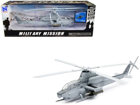 Sure, here is the corrected text from the image:
---
**NewRay**
**MILITARY MISSION**
**AGES 5+**
**DIE-CAST METAL**
**DISPLAY STAND INCLUDED**
**COLLECT THEM ALL**
**Bell AH-12 Cobra**
**WARNING: CHOKING HAZARD - Small parts. Not for children under 3 years.**
---
This text is grouped and corrected from the image provided.