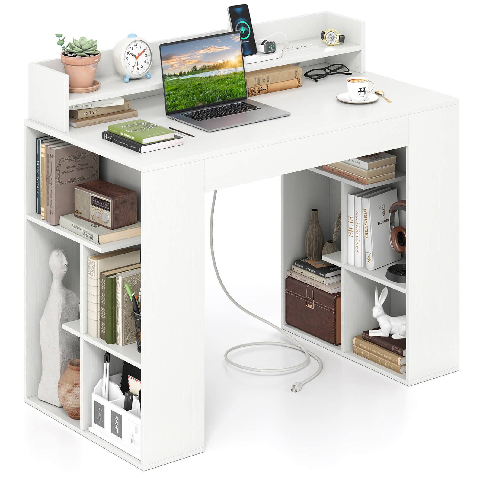 The image features a white desk with a laptop, a clock, and a mouse on it. There are also several books scattered around the desk, and a potted plant is placed nearby. Additionally, there is a cup on the desk, and a rabbit figurine can be seen on one of the shelves. The desk is well-organized, with a variety of items placed on it to create a functional workspace.