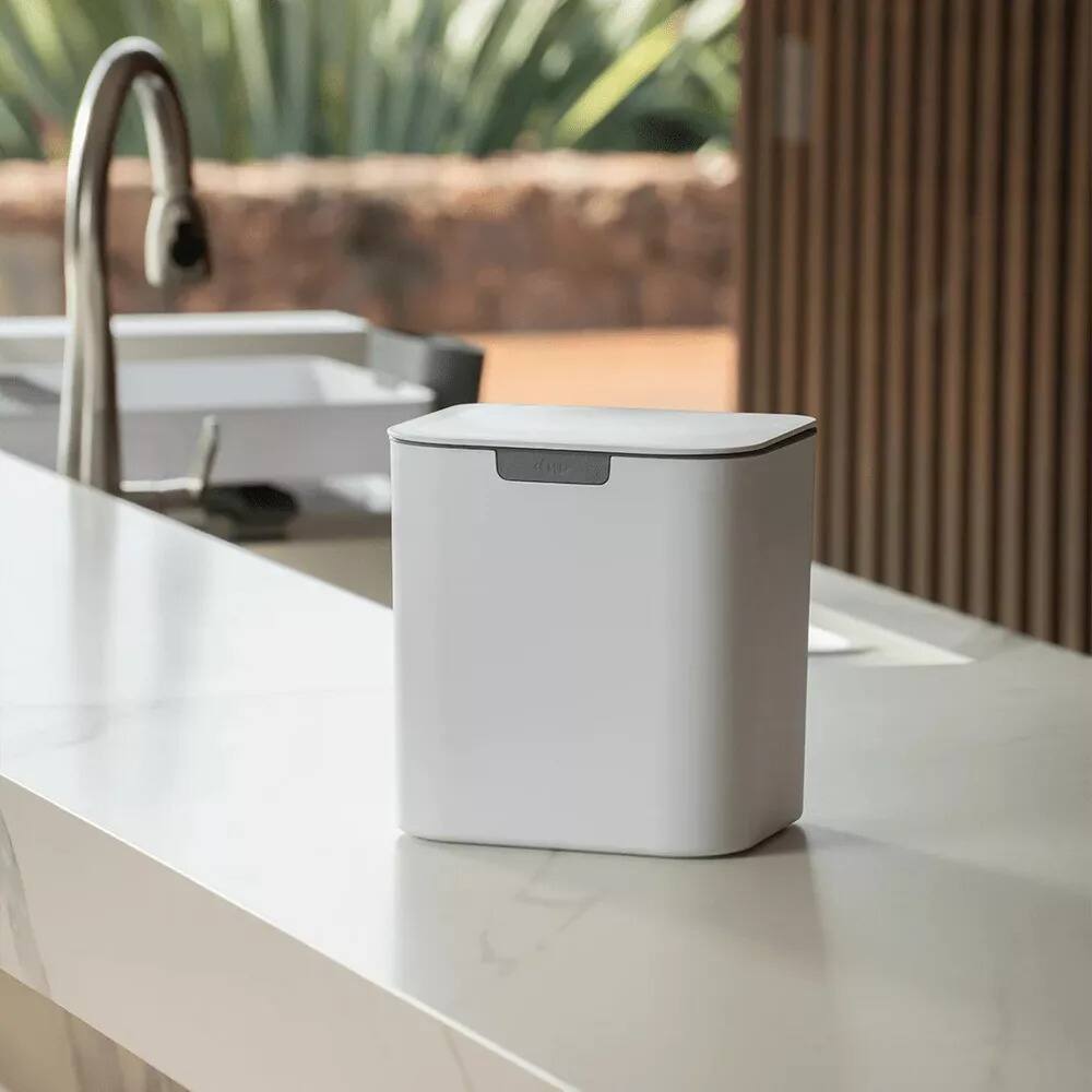 Left. OU - Wall-Mounted Bathroom Trash Can, 1.3 Gal Self-Adhesive Hanging Bin with Lid & Removable Bag Ring, Space-Saving Design - White.