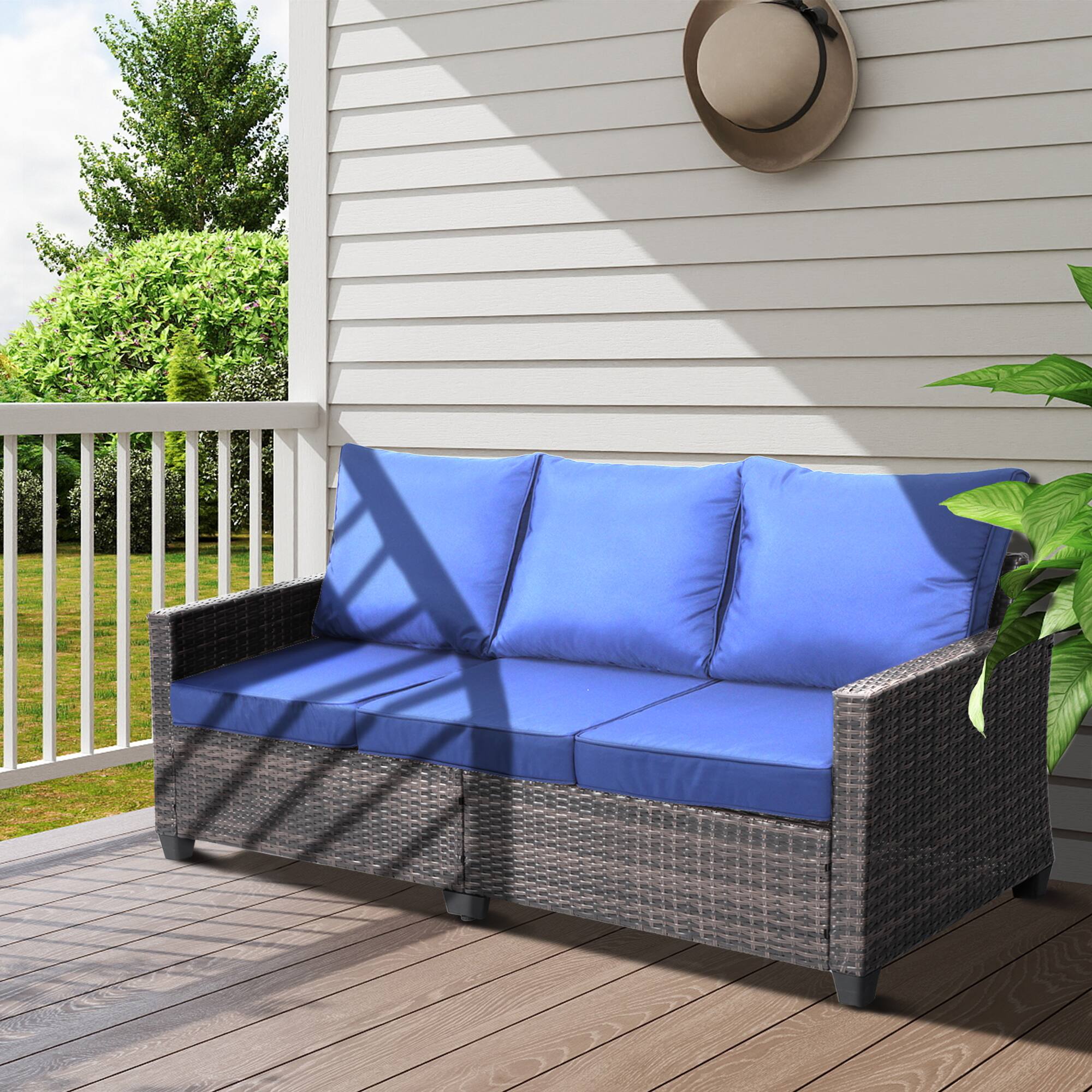 Angle. Decksplore - All-weather three-seater wicker patio sofa, premium outdoor furniture featuring brown wickerwork and thickened cushions - Blue.
