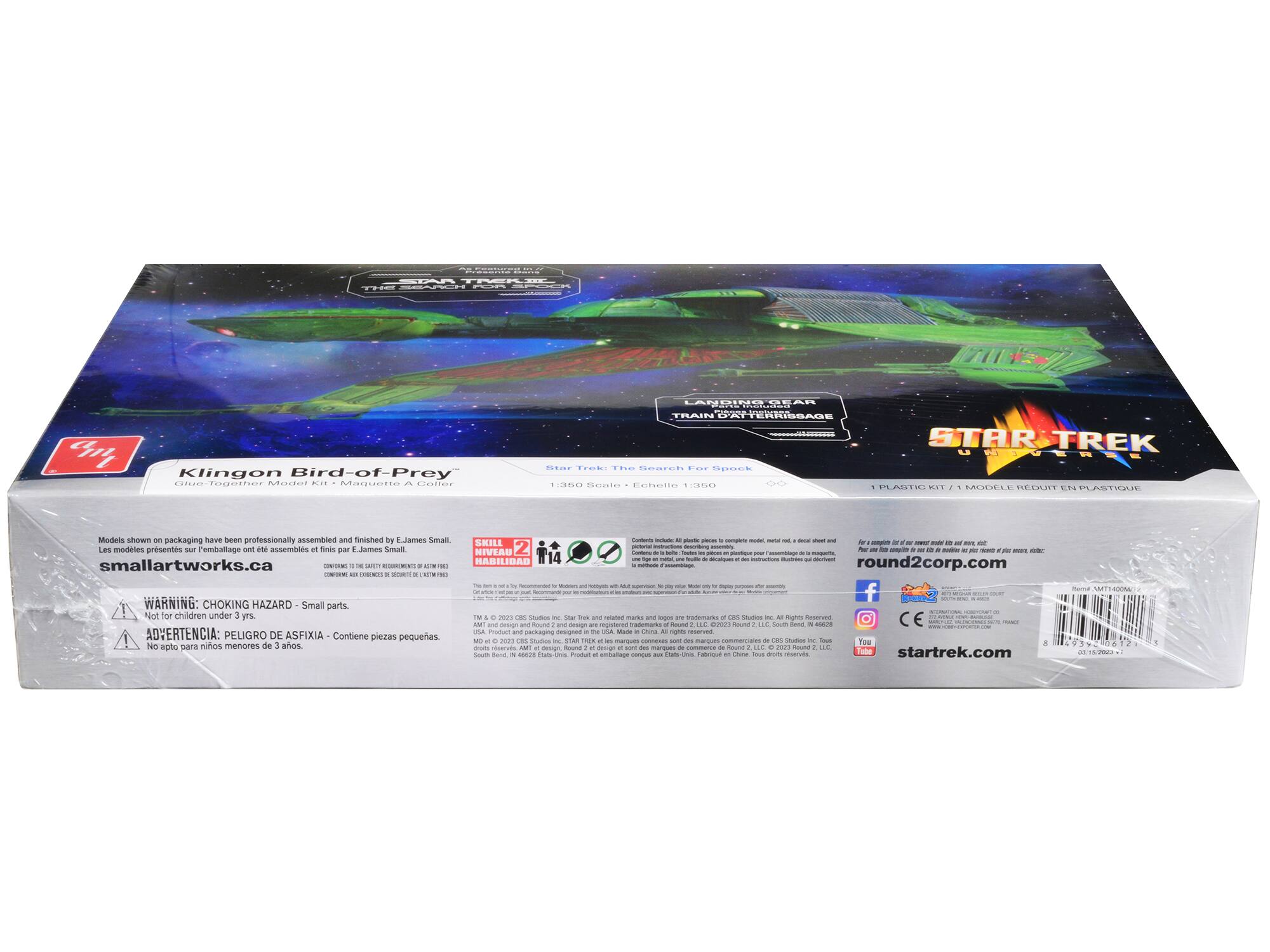 Sure, here is the corrected and grouped text from the image:

---

**Klingon Bird-of-Prey**

**STAR TREK**  
**THE NEXT GENERATION**  
**TRAIN OF THE FUTURE**

**Star Trek: The Search For Spock**

**1:350 Scale - Échelle 1:350**

**Skill Level 2**  
**Habilidad - Nivel 2**

**Models shown on packaging have been professionally assembled and finished by E. James Small.**  
**Les modèles présentés sur l'emballage ont été assemblés et finis par E. James Small.**

**WARNING: CHOKING HAZARD - Small parts.**  
**Not for children under 3 yrs.**  
**ADVERTENCIA: PELIGRO DE ASFIXIA - Contiene piezas pequeñas.**  
**No apto para niños menores de 3 años.**

**smallartworks.ca**

**round2corp.com**

**CE**

**startrek.com**

**1 PLASTIC KIT - 1 MODÈLE RÉDUIT EN PLASTIQUE**

**Contains include: All plastic pieces to assemble model, metal rod, decals sheet and