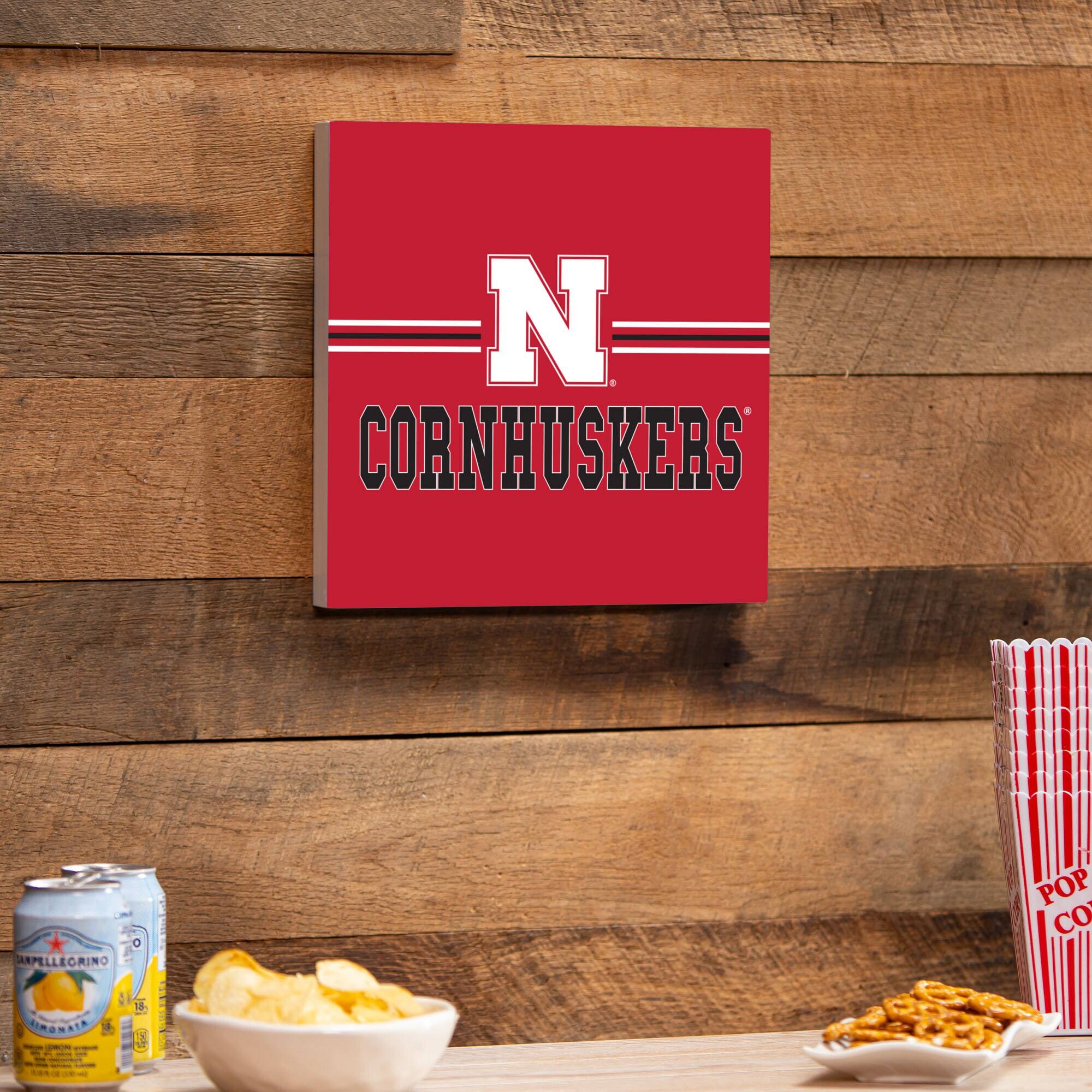 CORNHUSKERS  
N  
CORNHUSKERS  

ARPELLEGRINO  
POP CORN