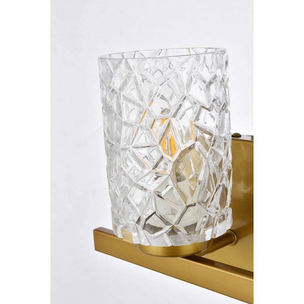 Left. Living District - Cassie 1 light bath sconce in brass with clear shade - Brass And Clear Shade.