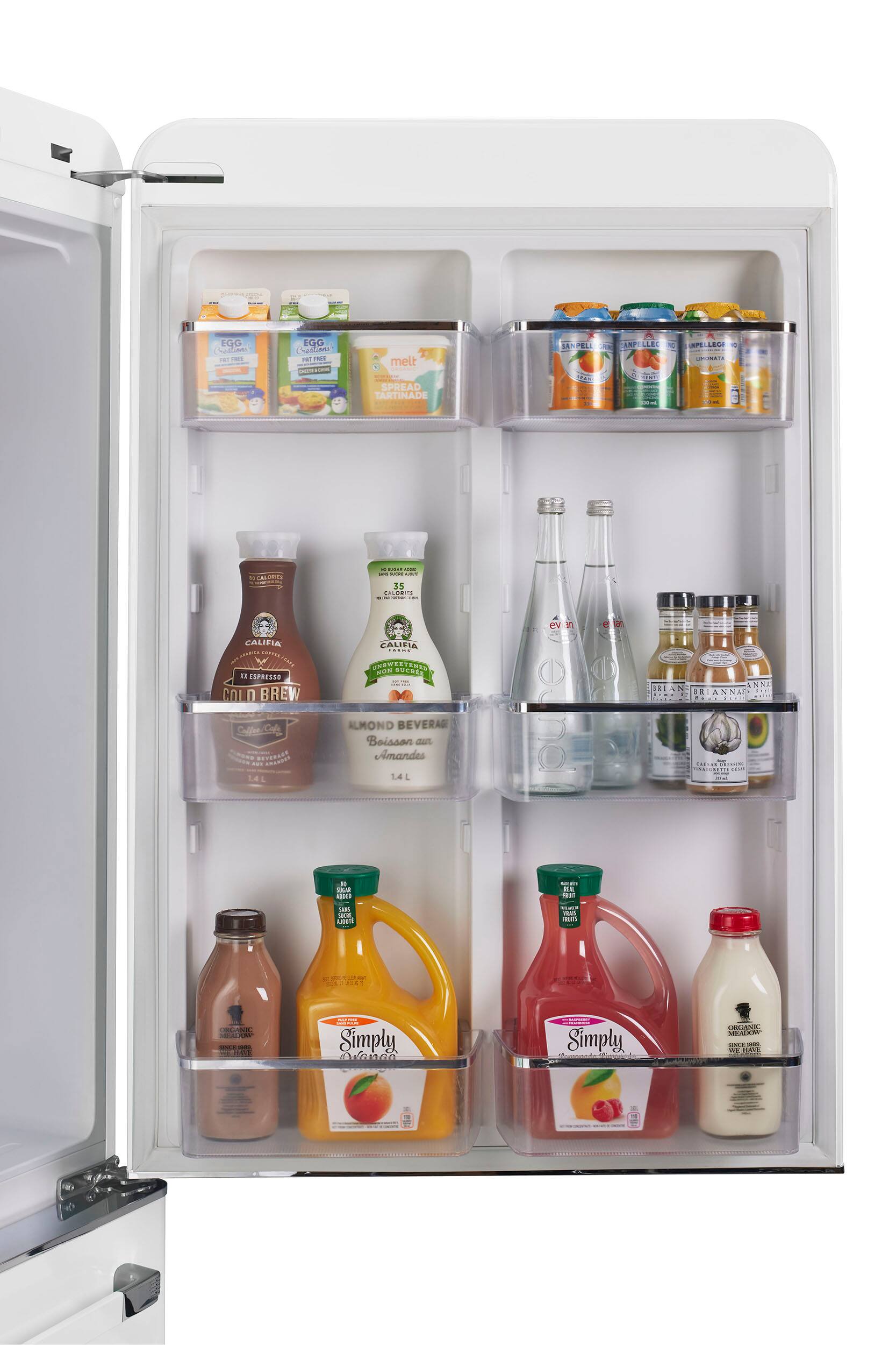 The image shows a refrigerator with its door open, revealing a variety of drinks and food items. There are several bottles of juice, milk, and other beverages placed on the shelves. Additionally, there are multiple bottles of almond milk and other milk products. A carton of eggs is also visible in the refrigerator. The refrigerator is well-stocked and organized, providing a variety of options for snacking and meal preparation.