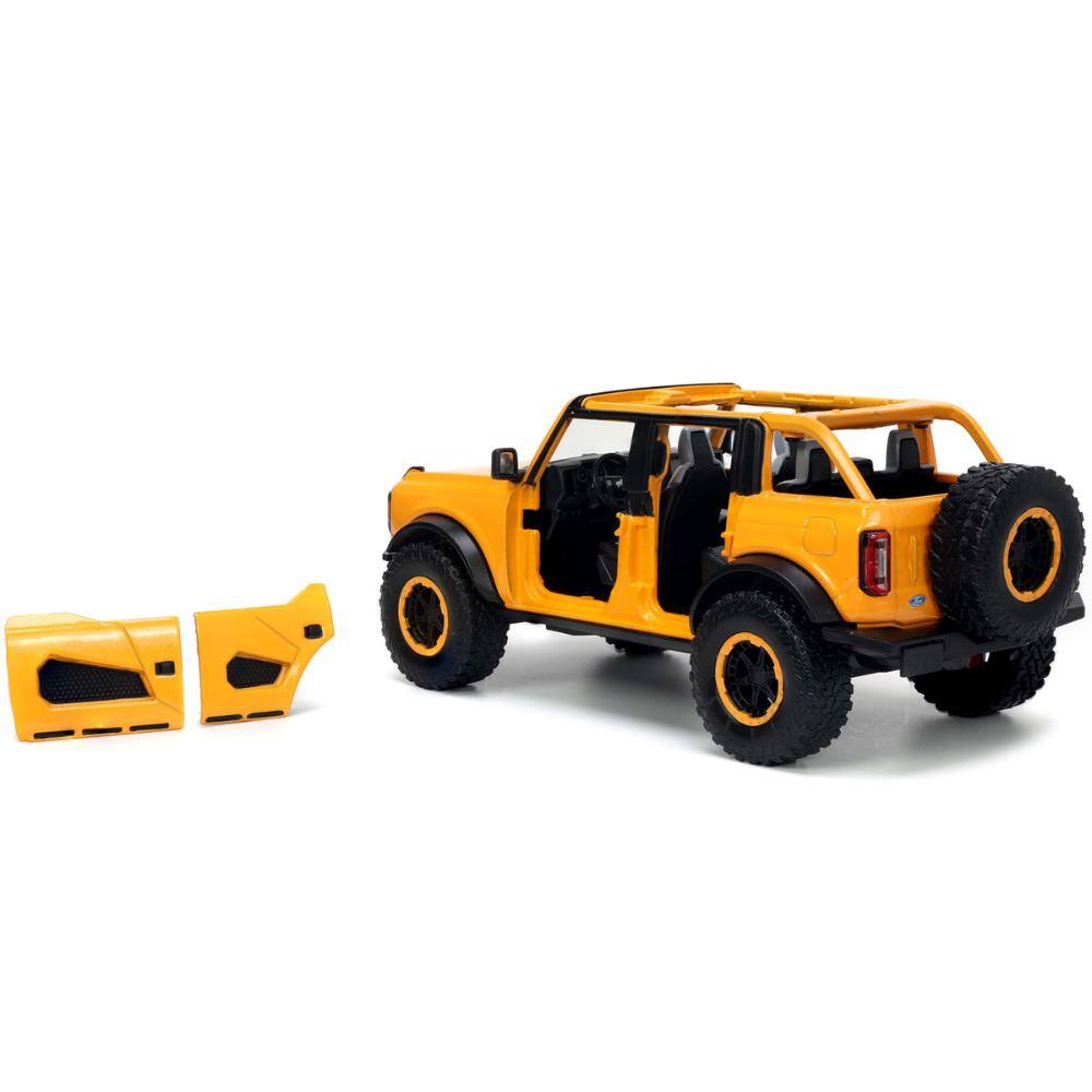 Left. Jada - 2021 Ford Bronco Orange Metallic with Extra Wheels "Just Trucks" Series 1/24 - Orange Metallic.