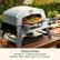 The image features a pizza oven with a pizza inside of it. The oven includes a 13-inch cordierite pizza stone, which reaches a temperature of 700°F and cooks pizza in just 6-8 minutes.