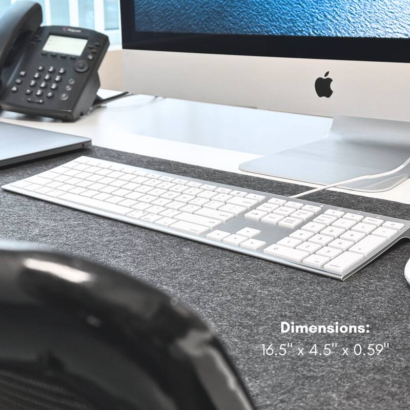 The corrected text is:

"Dimensions: 16.5" x 4.5" x 0.59""

The image shows a desk setup with a keyboard, monitor, and telephone.