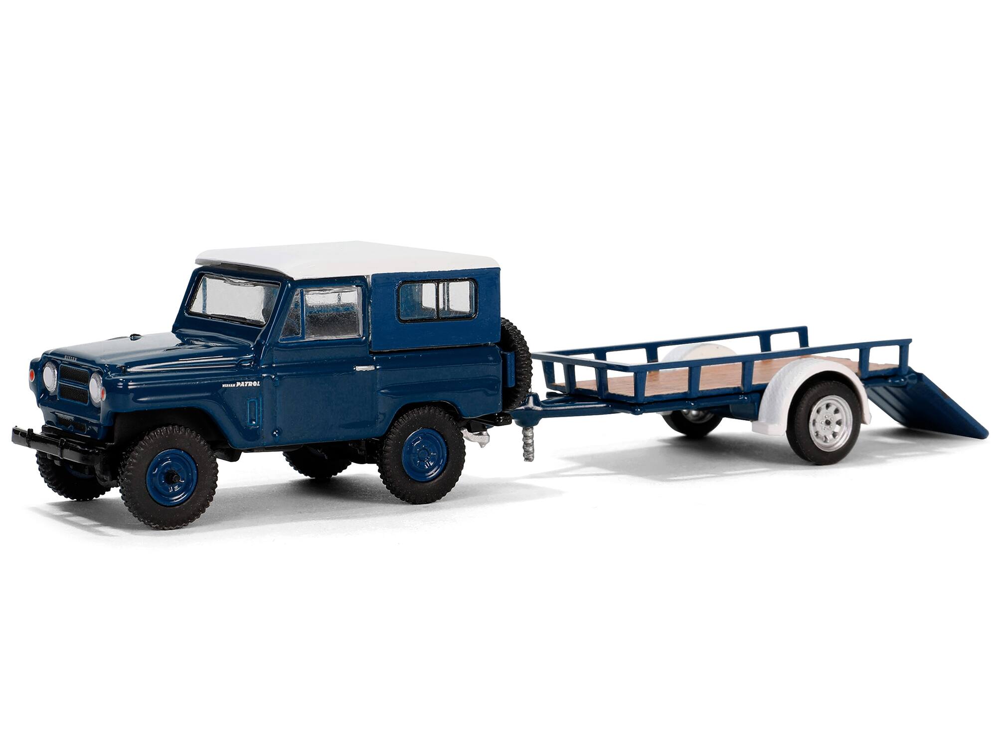 Angle. Greenlight - 1961 Nissan Patrol Blue with White Top and Utility Trailer "Hitch & Tow Series" 31 1/64 Diecast Model Car by Greenlight - Blue With White.