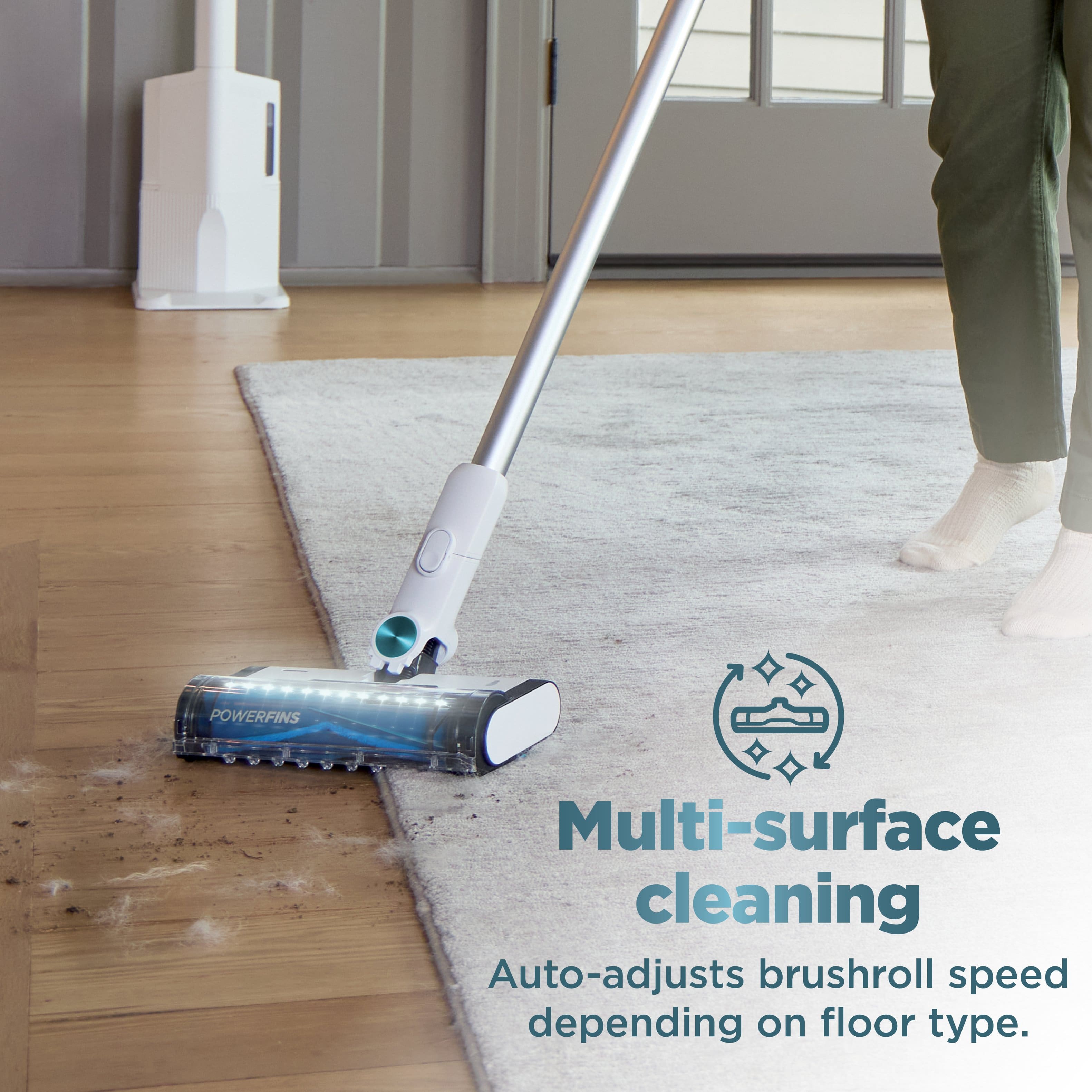 The text on the image reads: "POWERFINS Multi-surface cleaning Auto-adjusts brushroll speed depending on floor type."