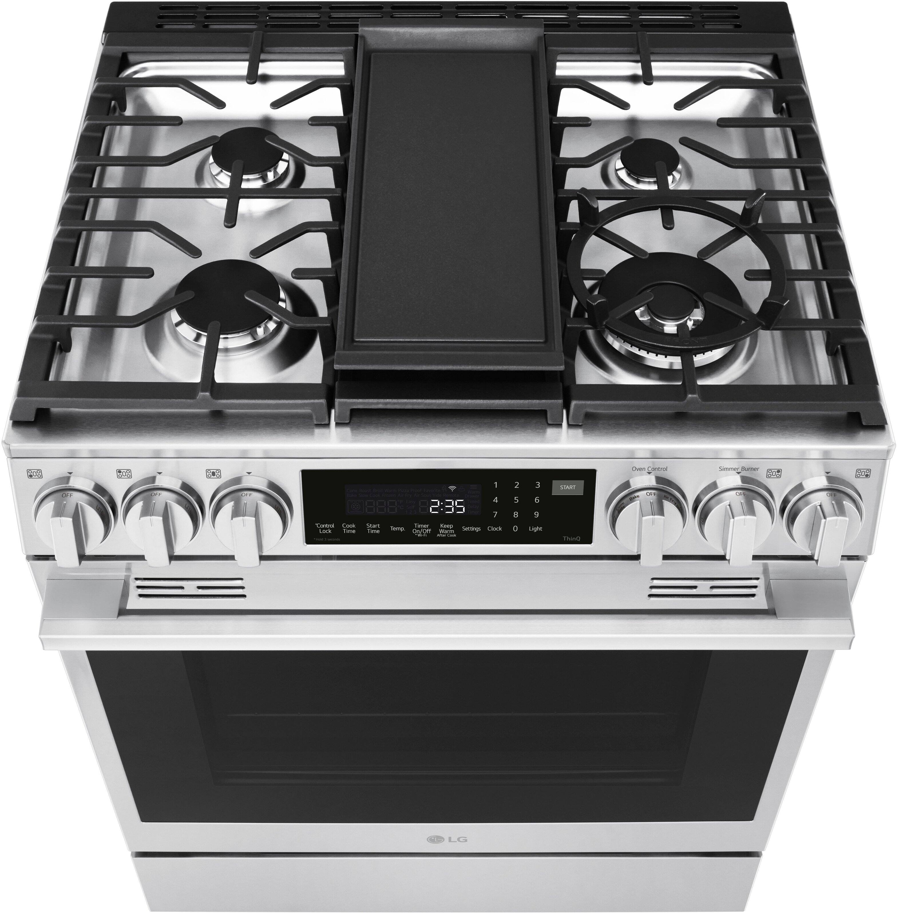 The image shows a stainless steel oven with a digital display showing the time and temperature of 2:35 and 235 degrees Fahrenheit. The oven has four burners on the top, with two on each side. The oven is a modern, sleek design, and it is likely a high-quality appliance for cooking and baking.