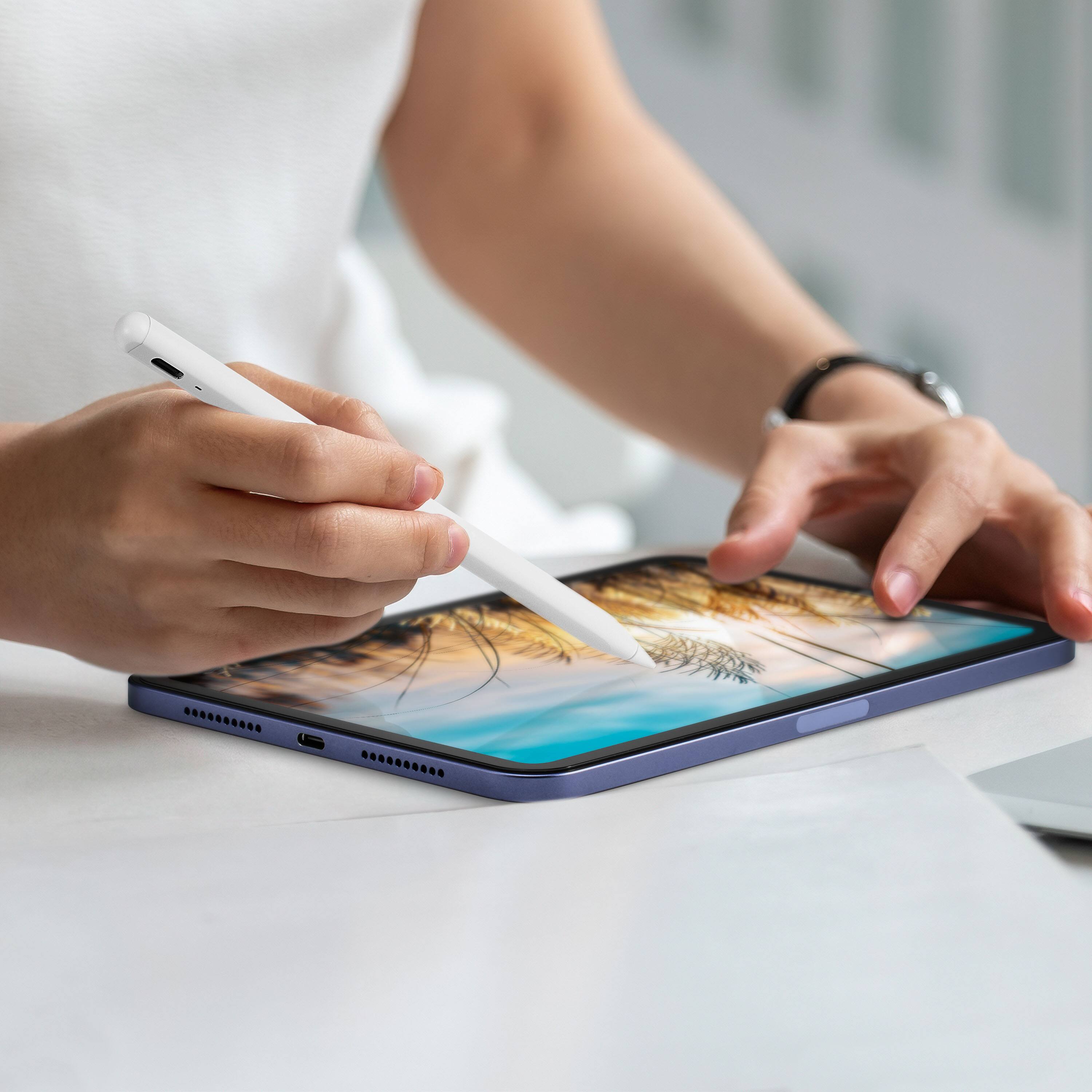 The image shows a person using a stylus on a tablet.
