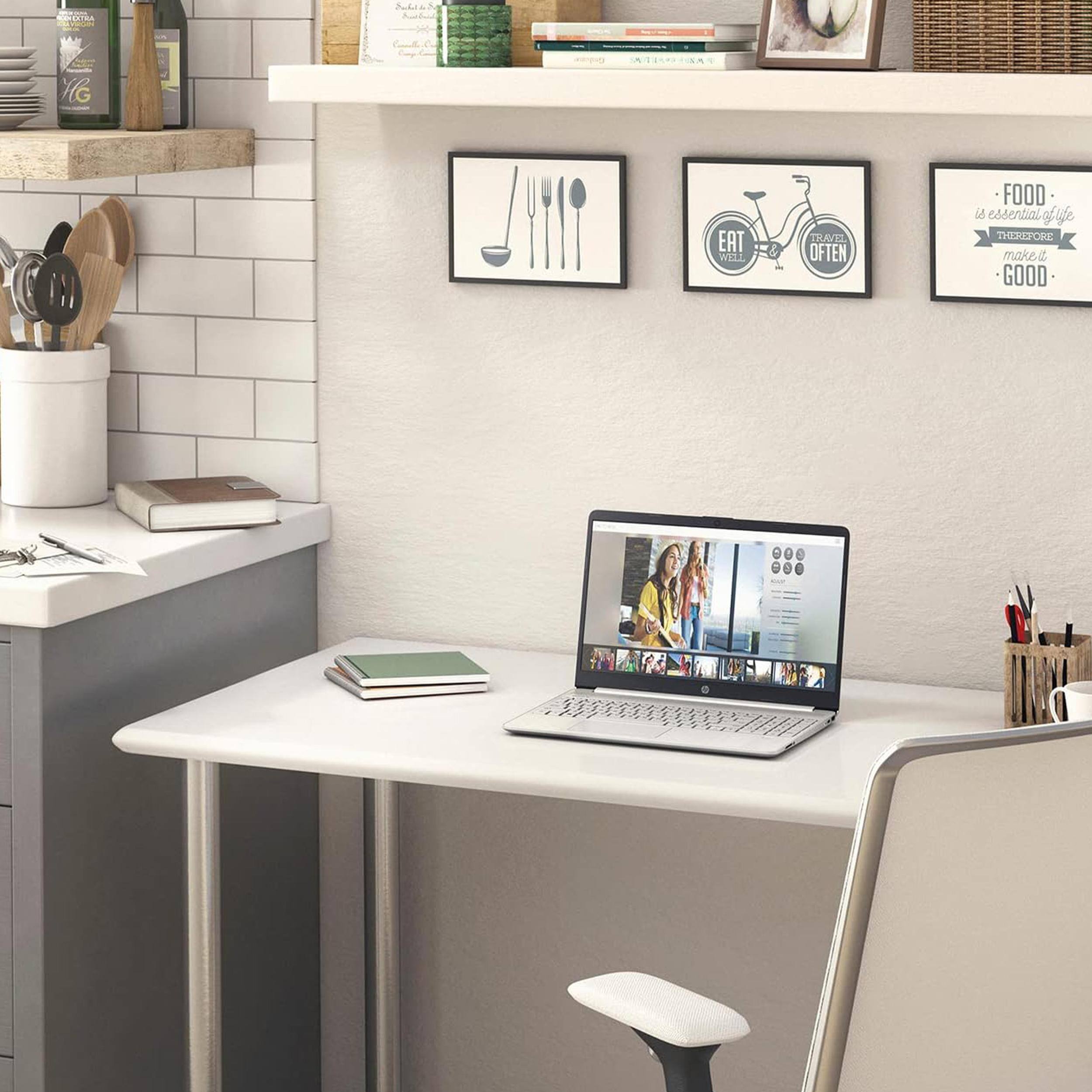 Sure, here is the corrected and grouped text from the image:

1. **On the wall:**
   - "FOOD is essential to life, therefore make it GOOD"
   - "EAT WELL TRAVEL OFTEN"

2. **On the laptop screen:**
   - "HG IL EAT W121 THAVEL OFTEN FOOD is essential to life therefore make it GOOD"

3. **On the shelf:**
   - "VIG" (on the bottle)
   - "Rustic & Co." (on the jar)

4. **On the desk:**
   - "HG" (on the notebook)

5. **On the laptop screen (video thumbnail):**
   - "HG" (on the video thumbnail)

This text is organized based on its location in the image.