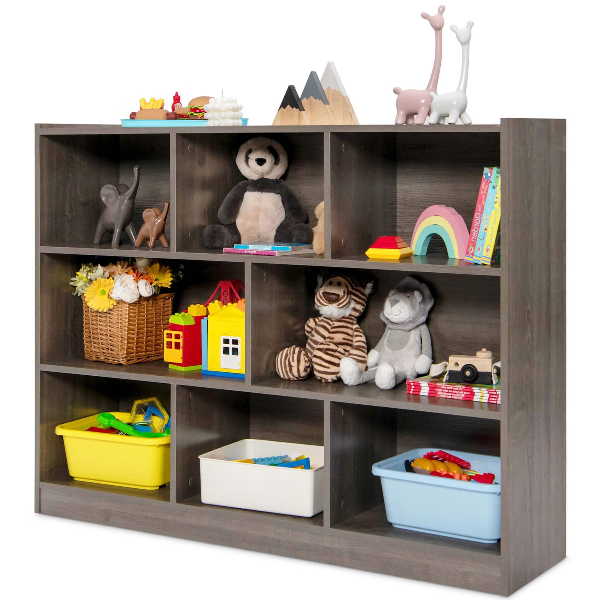 A toy shelf with a variety of toys, including a stuffed panda bear, a stuffed gorilla, and a stuffed monkey. There are also several books on the shelf, and a basket of toys.