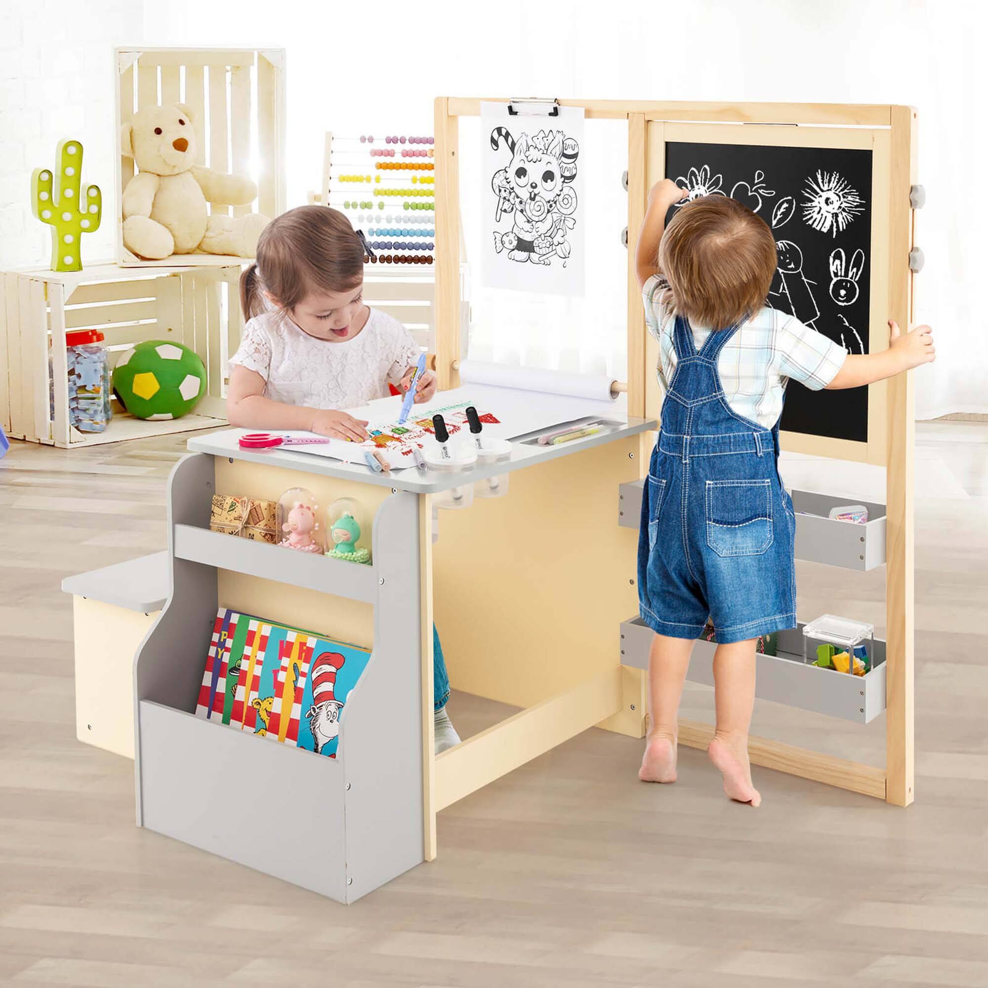 The image shows two children playing with toys and art supplies. One child is standing in front of a desk, while the other is sitting at the desk. The desk has a drawer, and the children are surrounded by various toys and art supplies, such as a teddy bear, a crayon, and a scissor. The children seem to be enjoying their time together, engaging in creative play and learning.