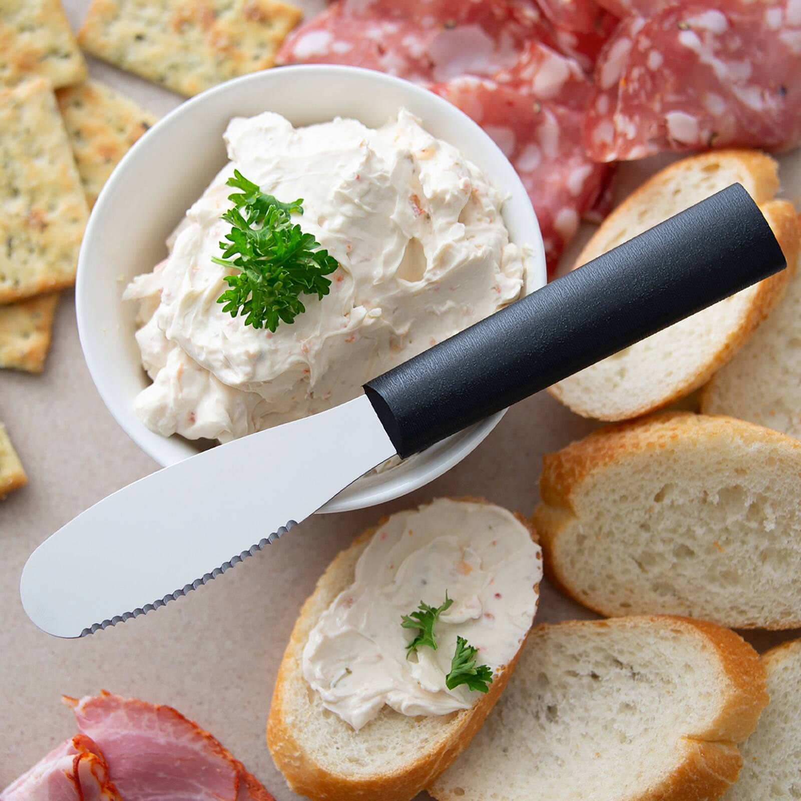 Alt View 1. Rada - Cutlery 3.375-Inch Party Spreader Stainless Steel Serrated Blade, Black Handle - Black.