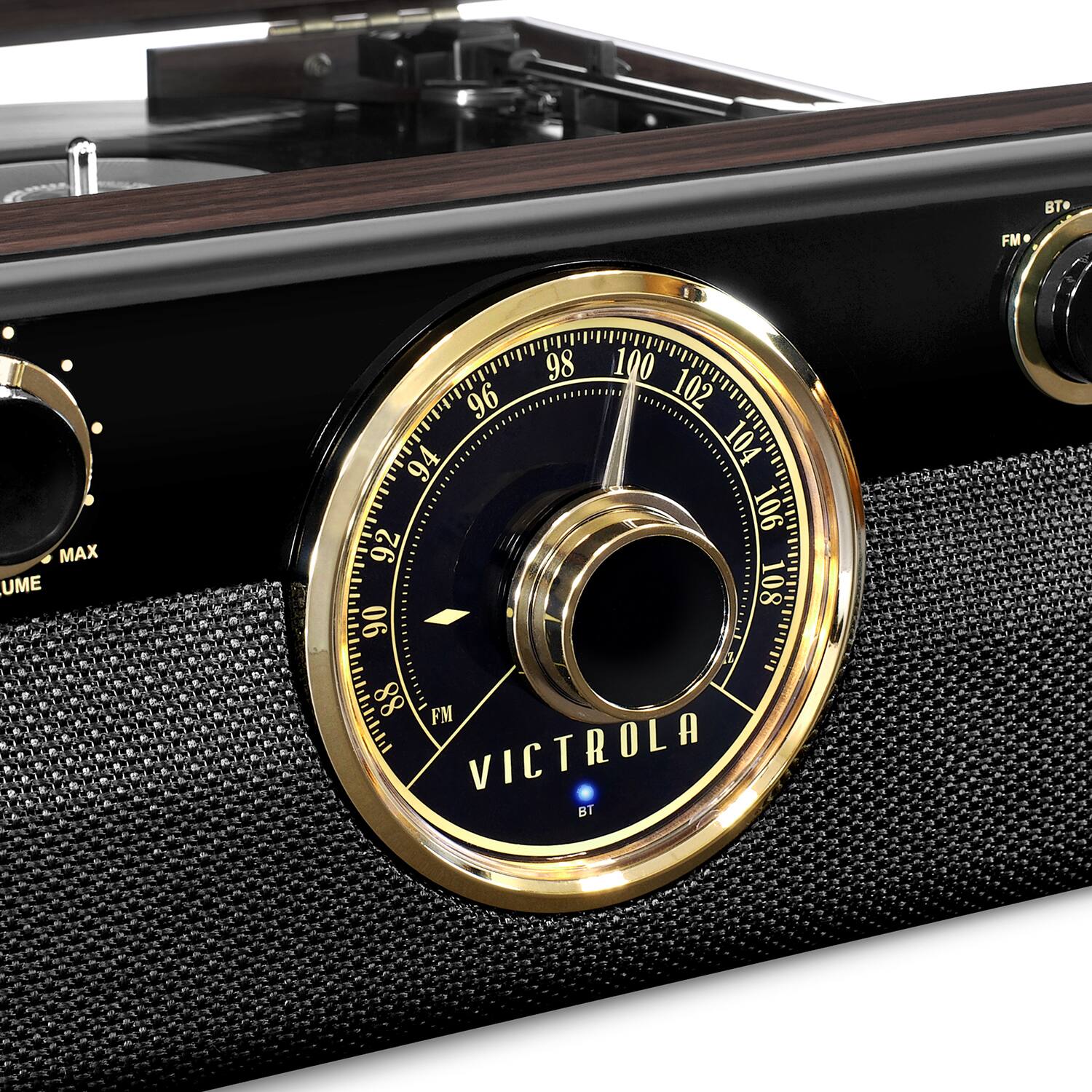 The image features a close-up of a radio with a dial showing the frequency of 98.1 FM. The radio is black and gold in color, and it appears to be an old-fashioned model. The dial is the main focus of the image, with the frequency displayed prominently.