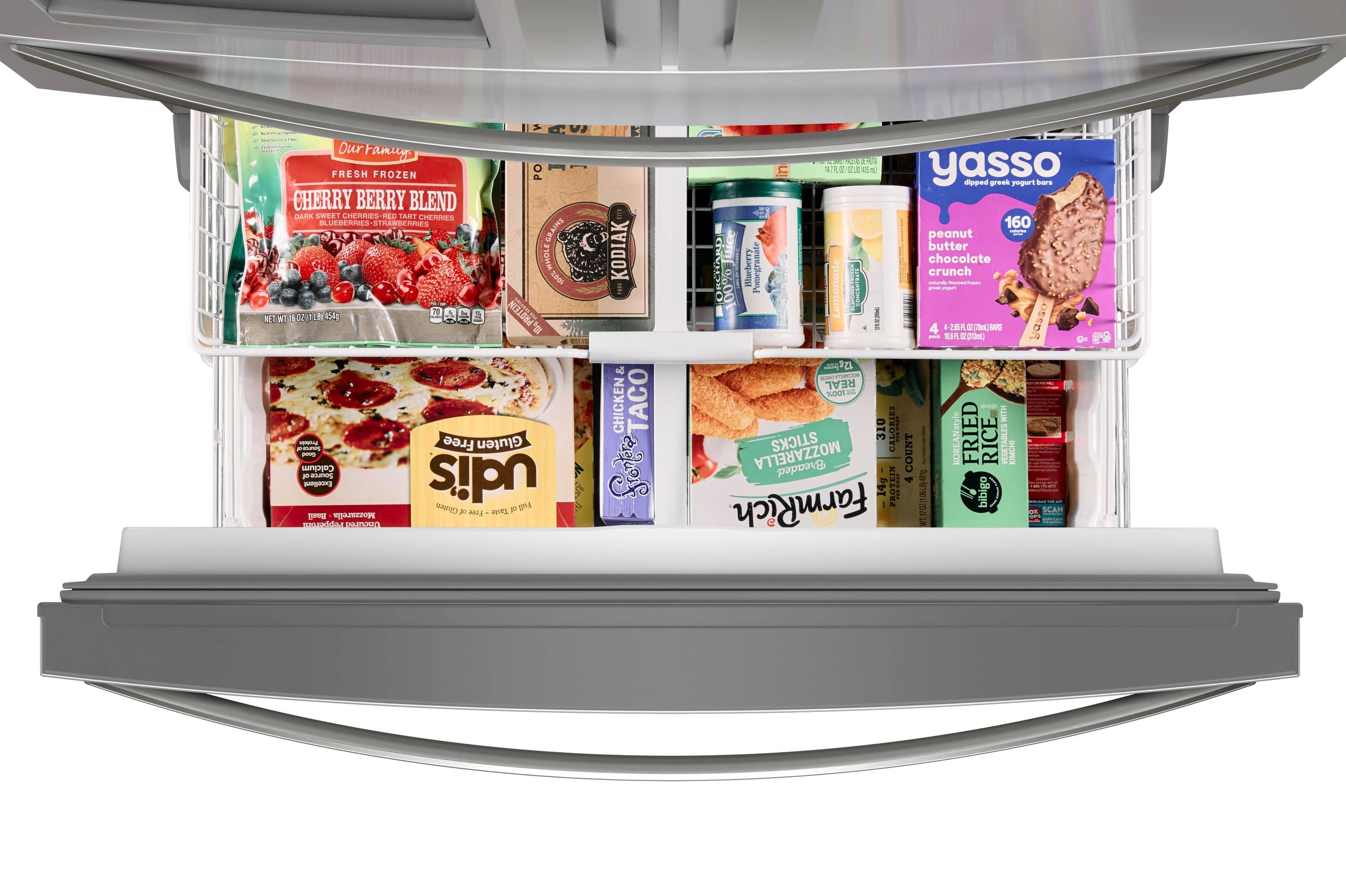 The image features a refrigerator with a variety of food items stored inside. There are several bottles, including a bottle of yogurt, and a box of chicken taco shells. Additionally, there are multiple packages of frozen food, such as frozen berries and frozen cherries. The refrigerator also contains a carton of milk and a container of peanut butter. The assortment of food items suggests that the refrigerator is well-stocked and ready for use.