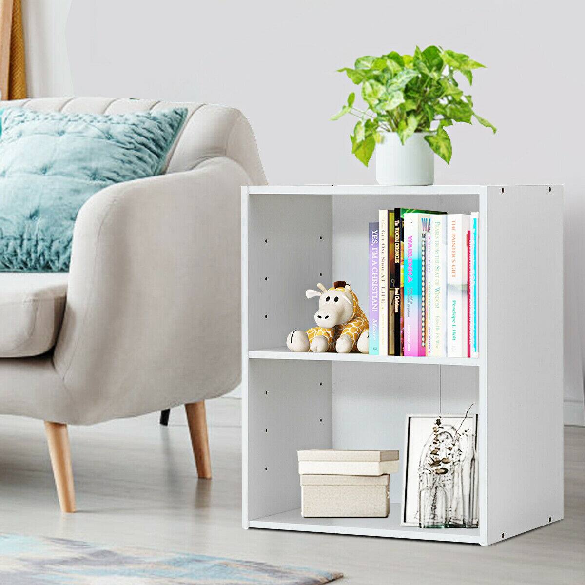 The image features a living room with a white bookshelf and a small white table. The bookshelf is filled with various books, and there is a small white vase with a plant in it on the table. The room also has a comfortable chair and a couch, creating a cozy and inviting atmosphere.