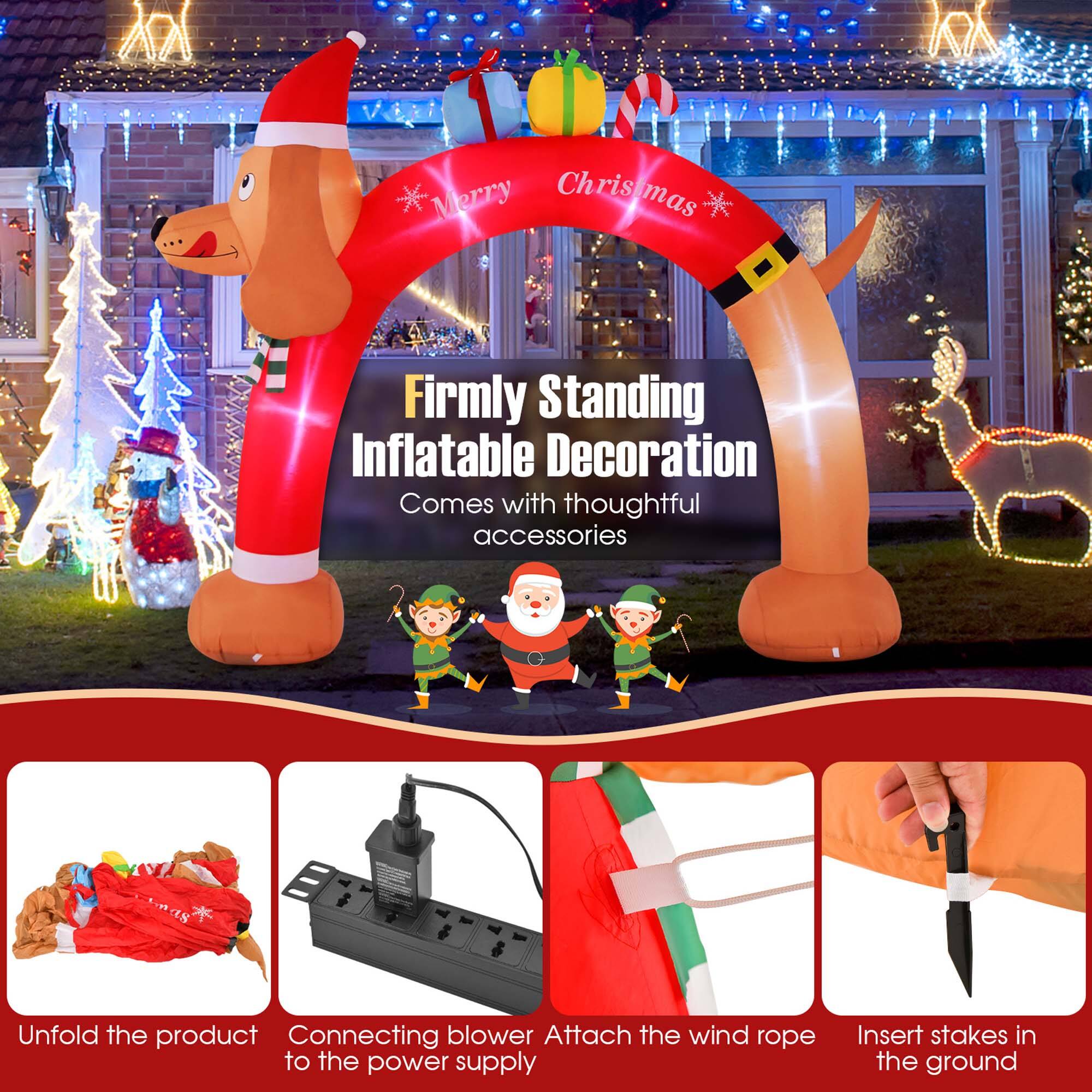 The image features a Christmas inflatable decoration that comes with thoughtful accessories. The product is designed to be firmly standing, and it includes a blower for inflation and a wind rope to secure it to the ground. The image also shows a person holding a knife, likely for cutting the rope or making adjustments to the inflatable.