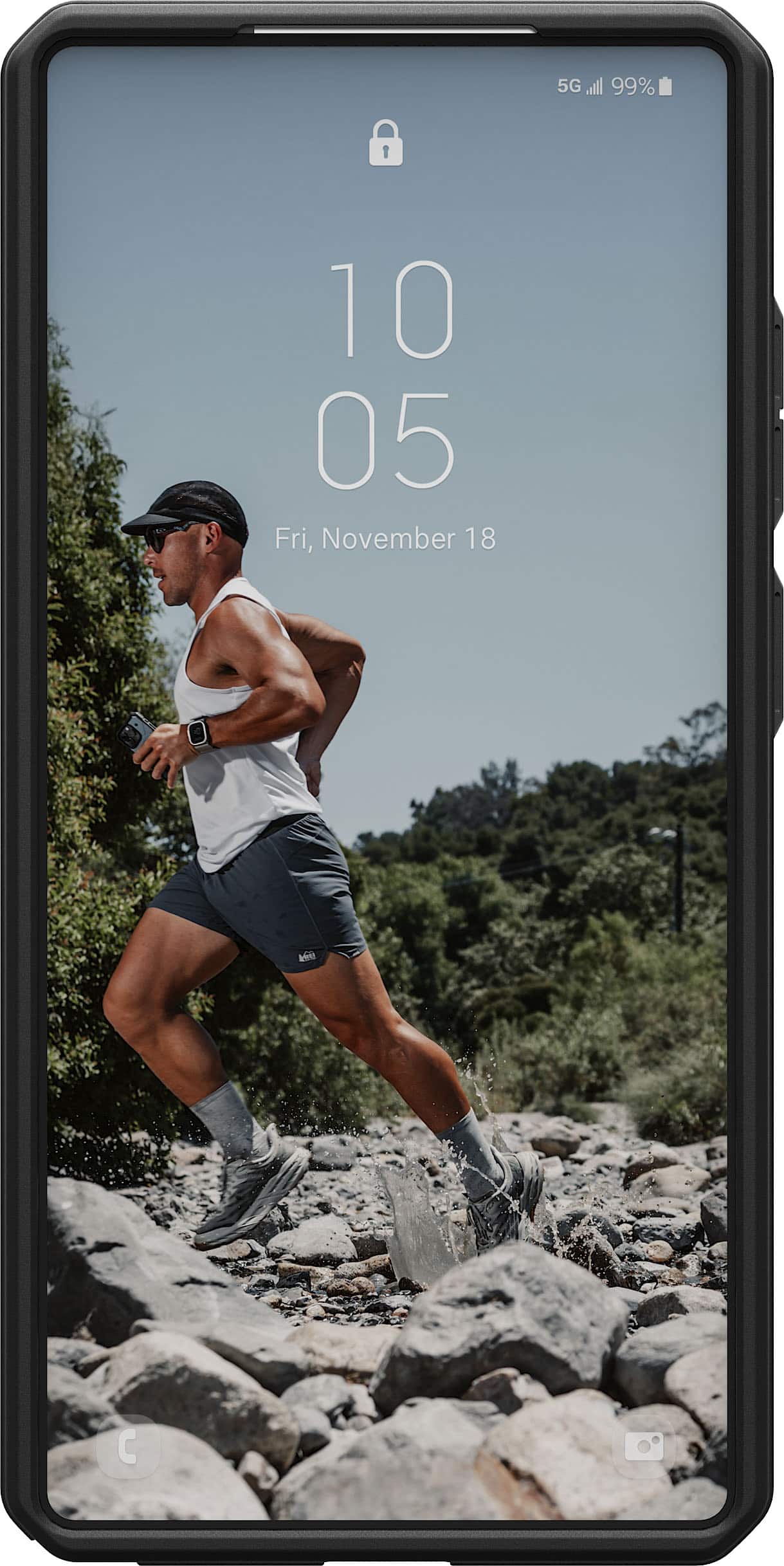 The text on the image reads: "5G 99% 10 05 Fri, November 18 M." This text indicates that the phone is connected to a 5G network, which is 99% available. The date is November 18, and the time is 10:05. The "M" at the end could be a typo or an abbreviation for "morning."