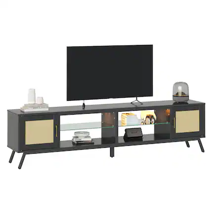 I cannot group or correct the text as it does not seem to be related to the image. The image features a large flat screen TV sitting on top of a TV stand, with a glass table in front of it. There are also several books and a remote control on the stand.