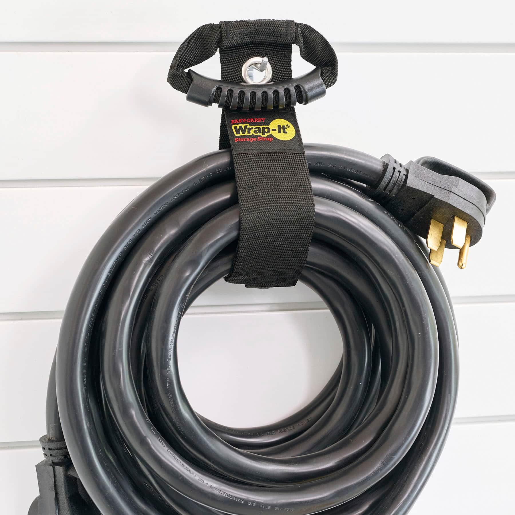 Wrap-It storage strap is easy to use and provides a convenient way to store and transport cords. It features a black strap and a metal hook, which can be attached to a wall or a piece of furniture to keep cords organized and out of the way. The strap is designed to hold up to 3 meters of cord, making it suitable for various applications. The Wrap-It storage strap is available in black and is made of high-quality materials to ensure durability and long-lasting performance.