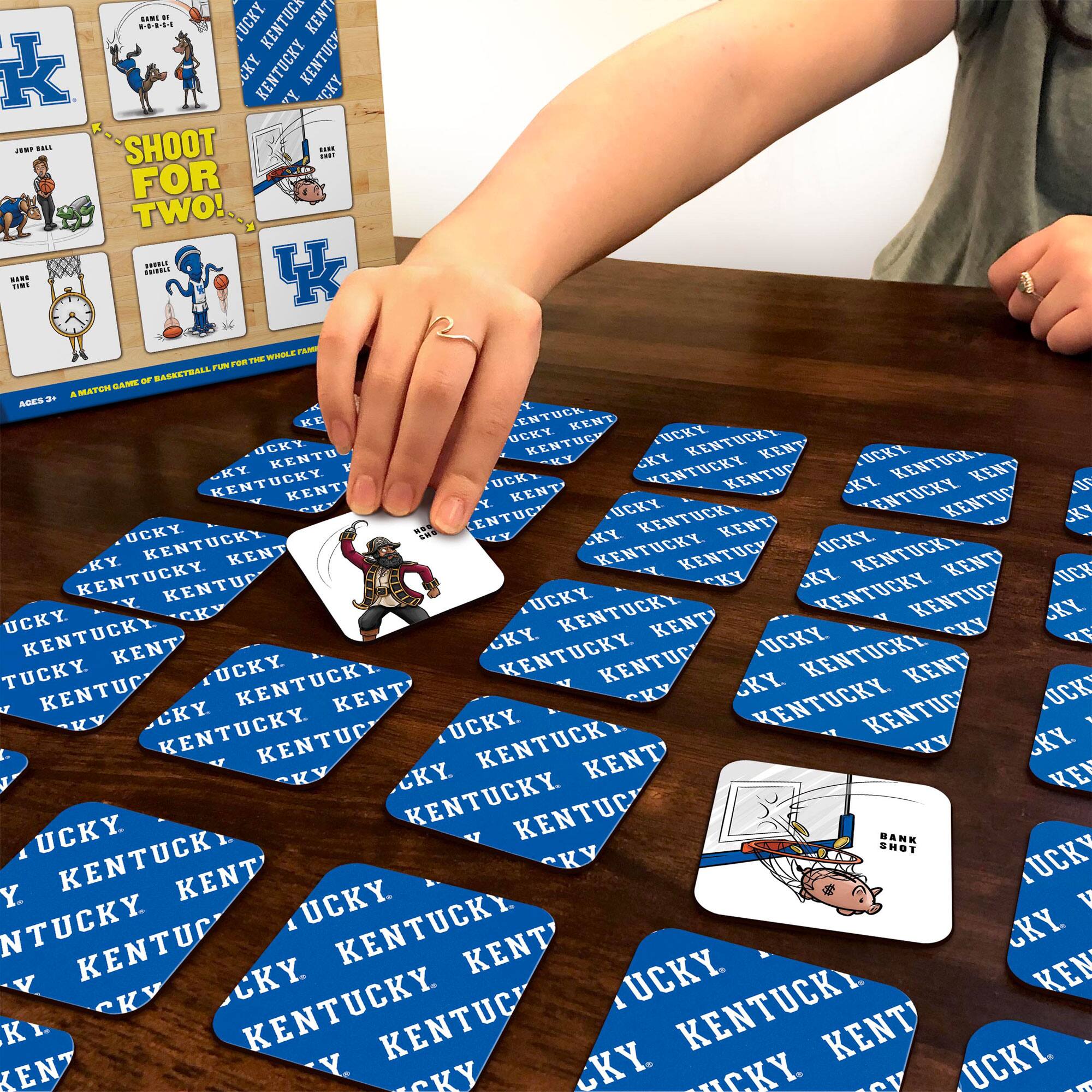 Sure, here is the corrected and grouped text:

**Top Left Card:**
- "SHOOT FOR TWO!"
- "JUMP BALL"
- "BANK SHOT"
- "AGES 8+"
- "A MATCH GAME OF BASKETBALL, FUN FOR THE WHOLE FAMILY"

**Top Right Card:**
- "KENTUCKY"
- "UK"

**Bottom Left Card:**
- "BANK SHOT"

**Bottom Right Card:**
- "KENTUCKY"
- "UK"

**Tokens:**
- "KENTUCKY"
- "UK"