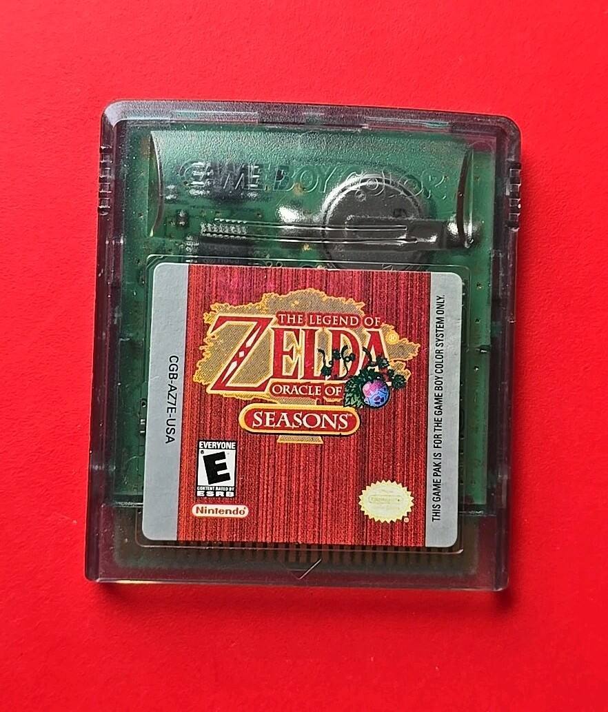 The text on the image is: "GAME BOY THE LEGEND OF ZELDA ORACLE OF SEASONS CGB-AZ7E-USA EVERYONE Nintendo" - E (Everyone)
