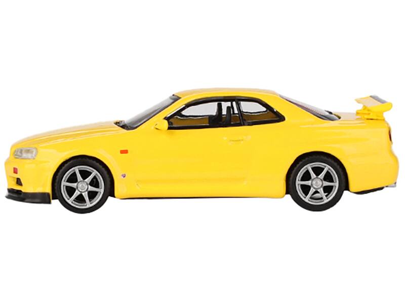 Angle. Mini GT - Nissan Skyline GT-R (R34) V-Spec RHD (Right Hand Drive) Lightning Yellow Limited Edition to 7920 pieces Worldwide 1/64 - Yellow.