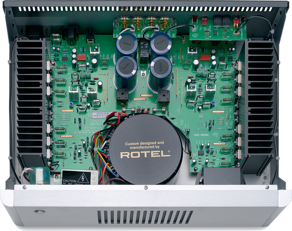 The text on the image reads: "Pn - 130515 RETOC U DAC 130515 8 anan anos ... Ru X-292 GLODES 130515 SRA S S /4259-0140 L LU 1 CAUTION: Do not use this equipment near water or in damp locations. Clean with dry cloth. Custom designed and manufactured by ROTEL."