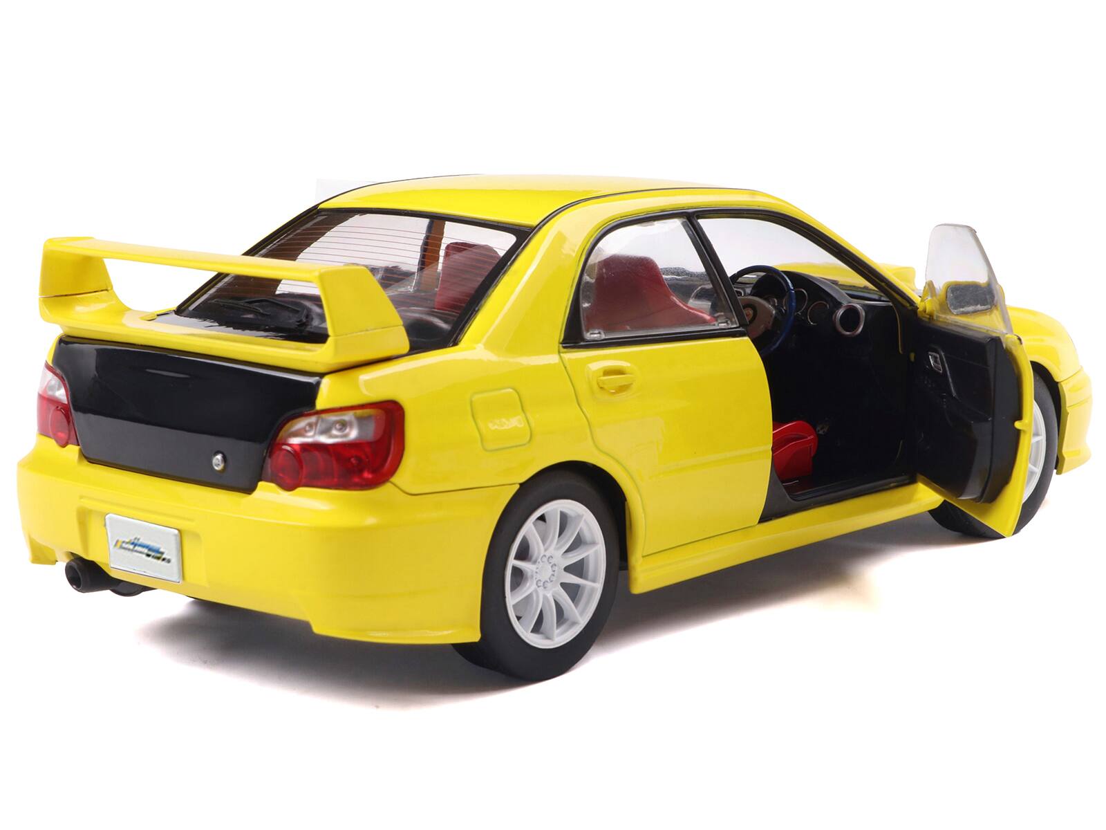 Back. Solido - 2003 Subaru Impreza WRX STI RHD (Right Hand Drive) Yellow with Carbon Hood 1/18 Diecast Model Car by Solido - Yellow.