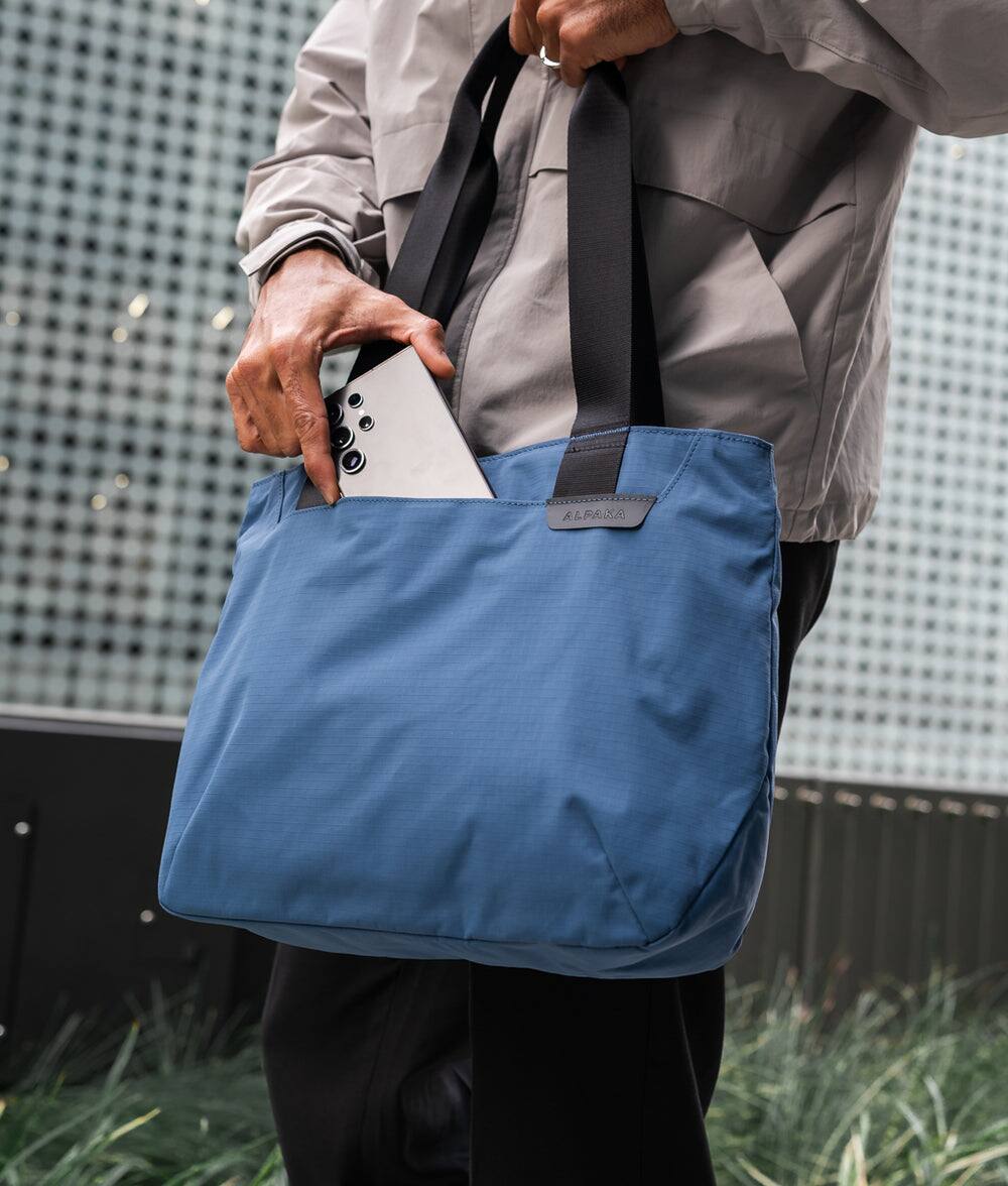 Left. ALPAKA - Elements Tote 9L Small Tote Bag for 11" Devices - Blue Axoflux 210D.