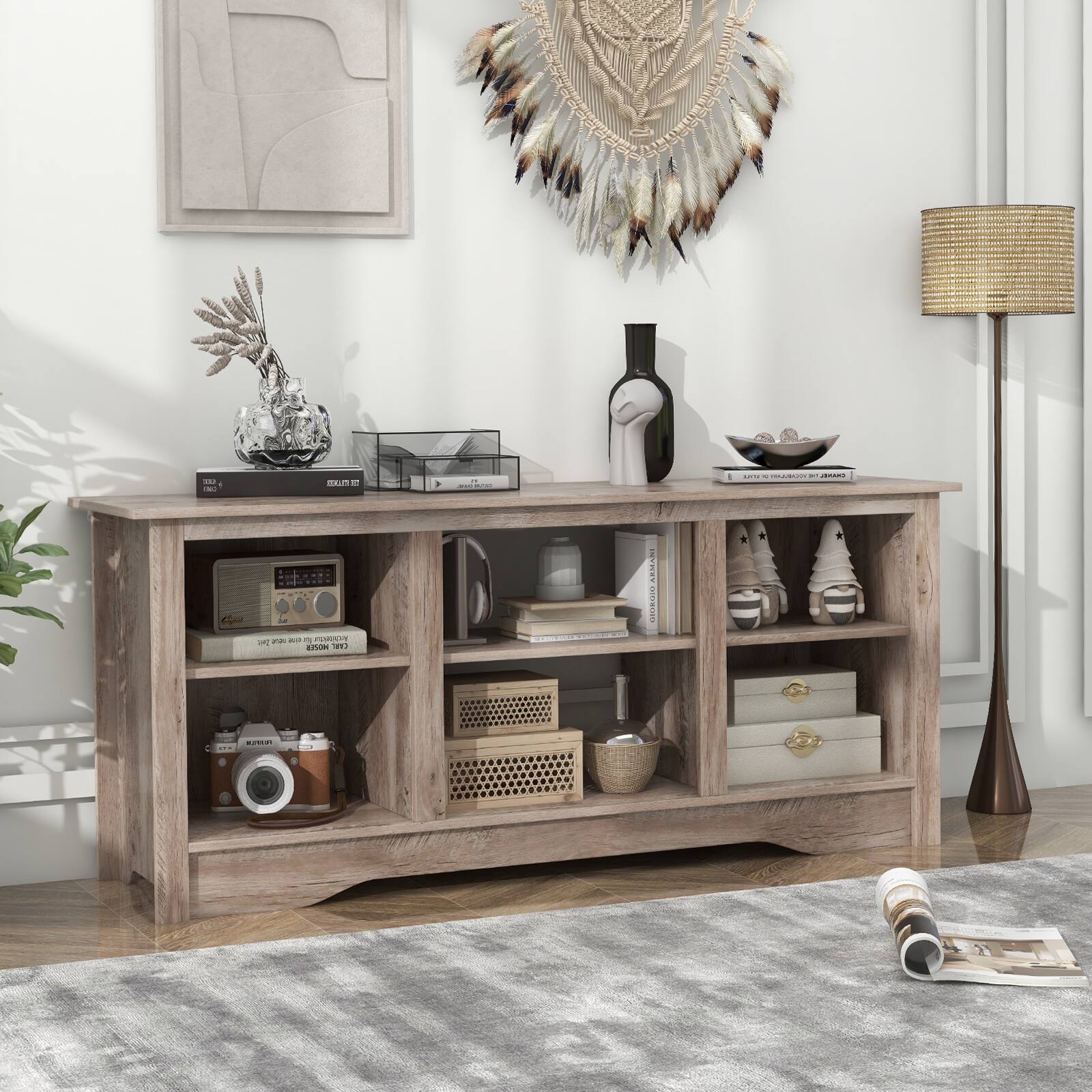 A wooden entertainment center with a variety of items on it.
