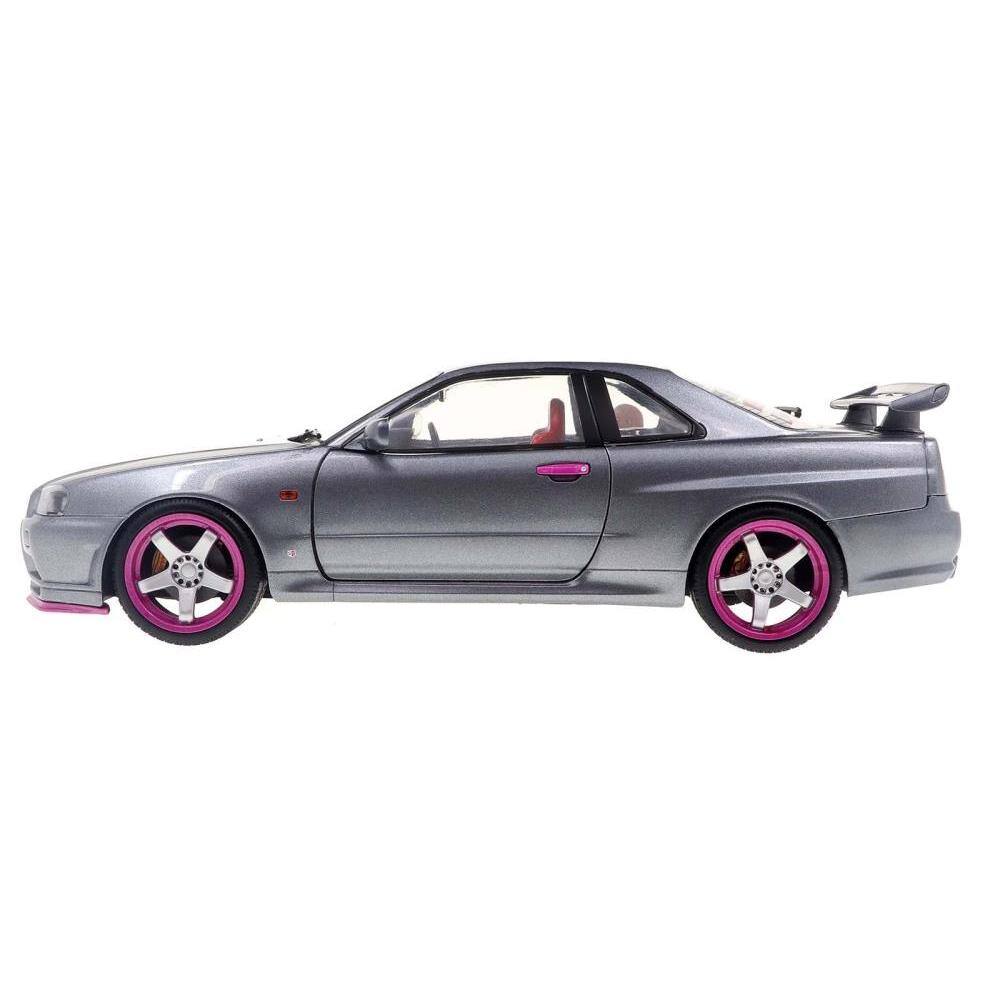 Left. Solido - 1999 Nissan Skyline GT-R (R34) RHD (Right Hand Drive) Silver Metallic with Purple Wheels 1/18 - Silver Metallic and Purple.