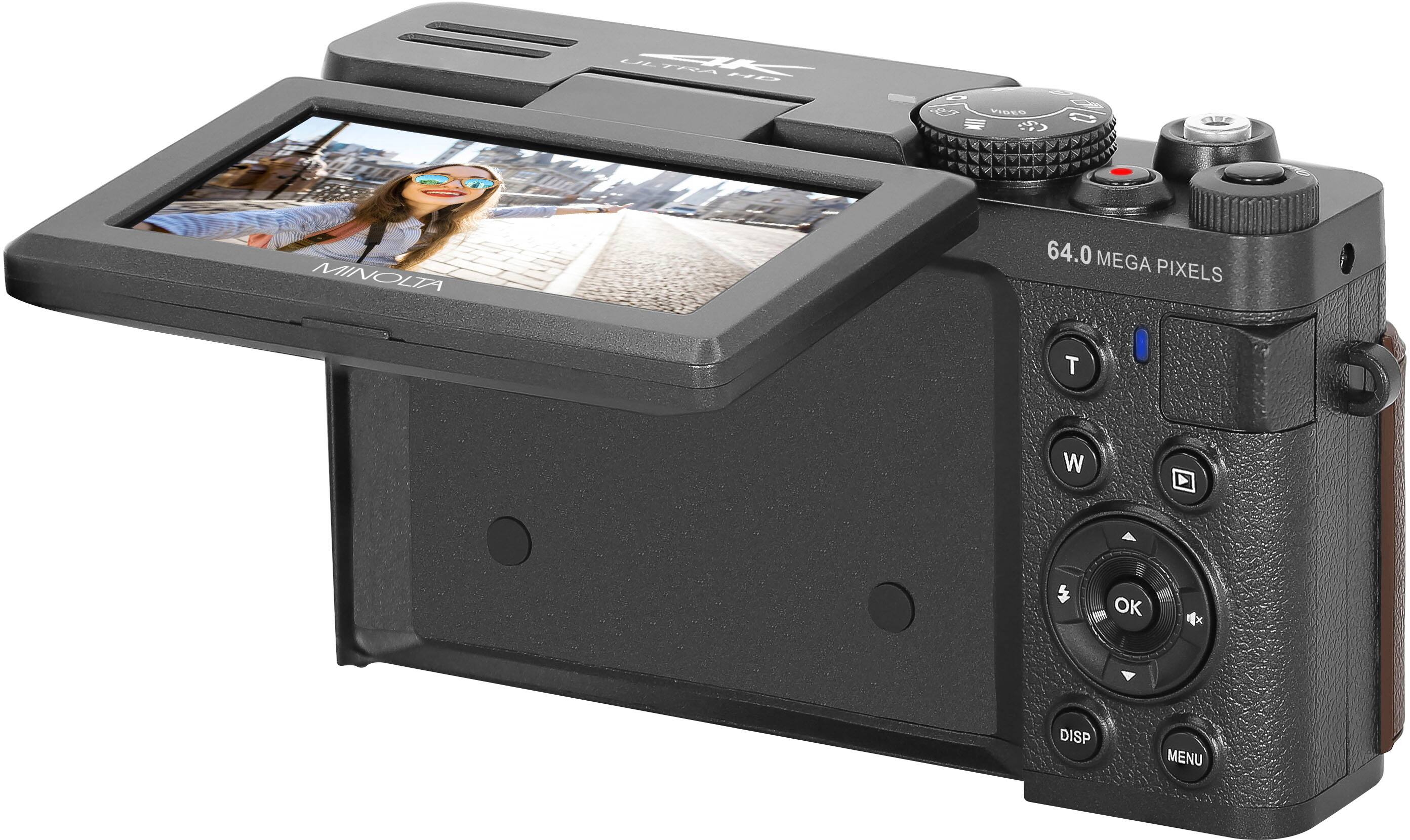 The text on the image reads: "Tram I Vides 1 MINOLIA 64.0 MEGA PIXELS T W OK DISP MENU."