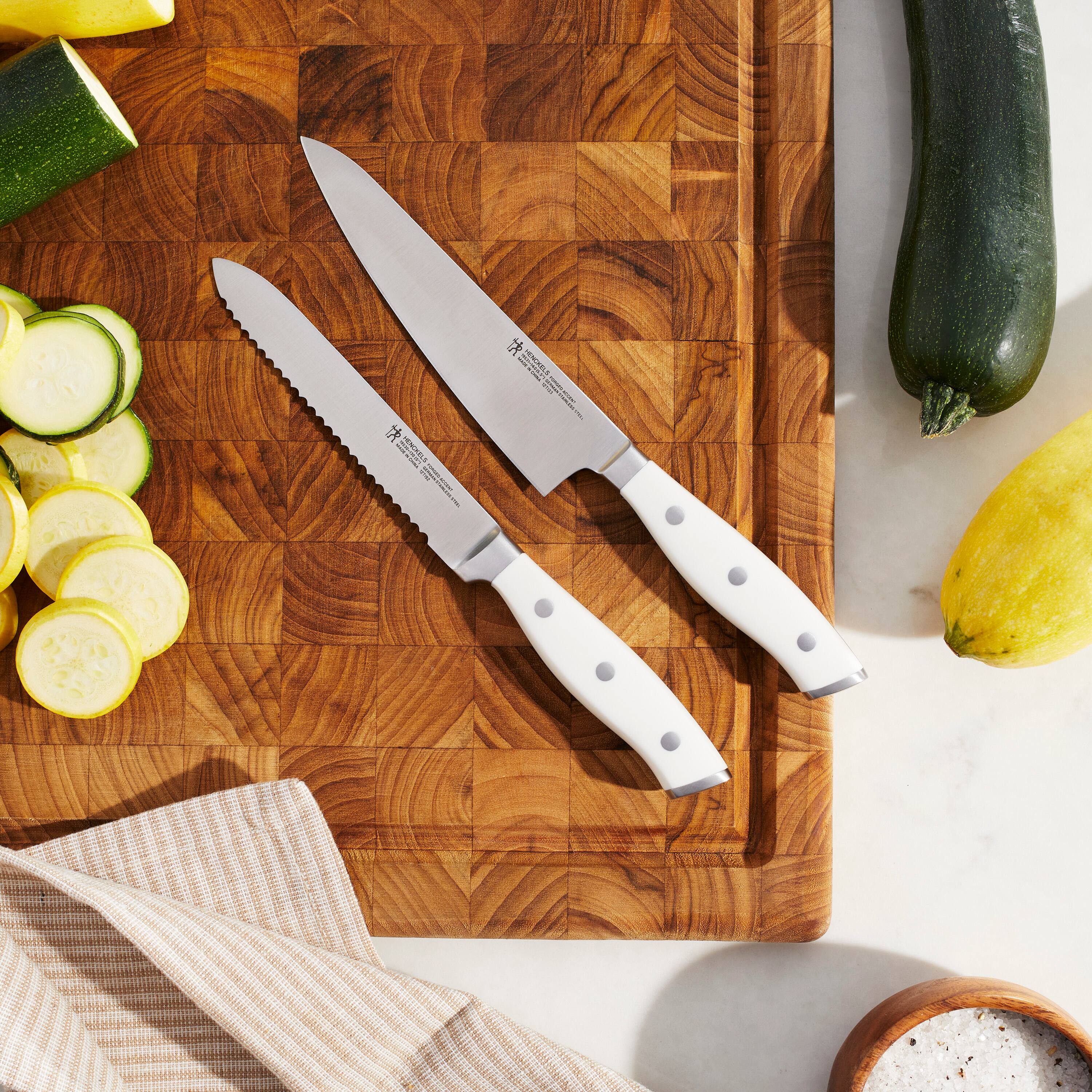 The text on the knives reads:

"ZWILLING
J.A. HENCKELS
SOLINGEN
GERMANY
1891"