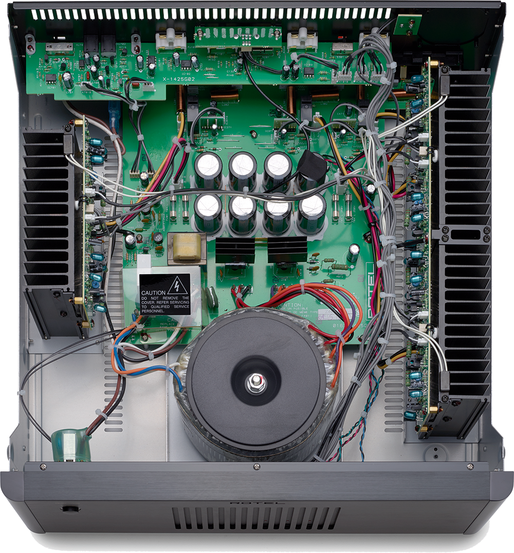 The image shows a close-up of a circuit board with various electronic components, including a speaker, a microphone, and a power supply. The circuit board is surrounded by wires, and the components are connected to a power source. The text on the image reads "CAUTION: DO NOT OPERATE EQUIPMENT WITH COVER REMOVED OR UNPLUGGED." This warning is likely to ensure the safety of the user and the proper functioning of the equipment.