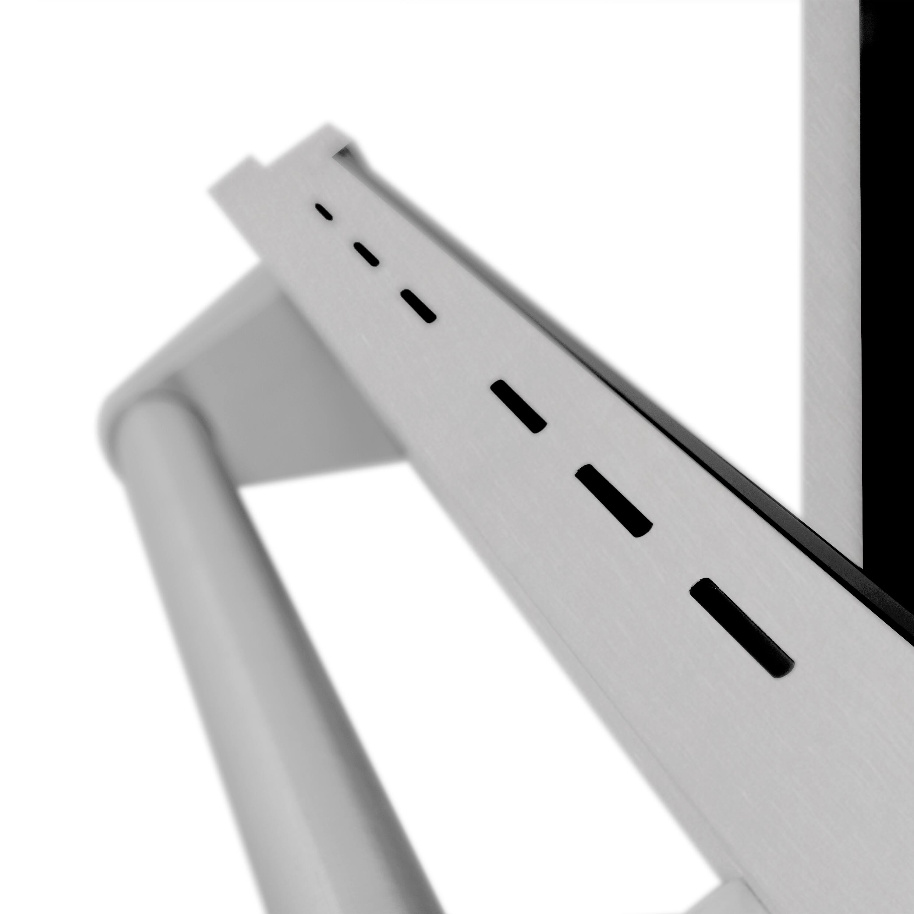 The image features a metal bracket or stand that is holding up a piece of metal. The metal bracket is positioned in the foreground, while the metal piece is in the background. The stand is designed to support the metal piece, providing stability and structure.