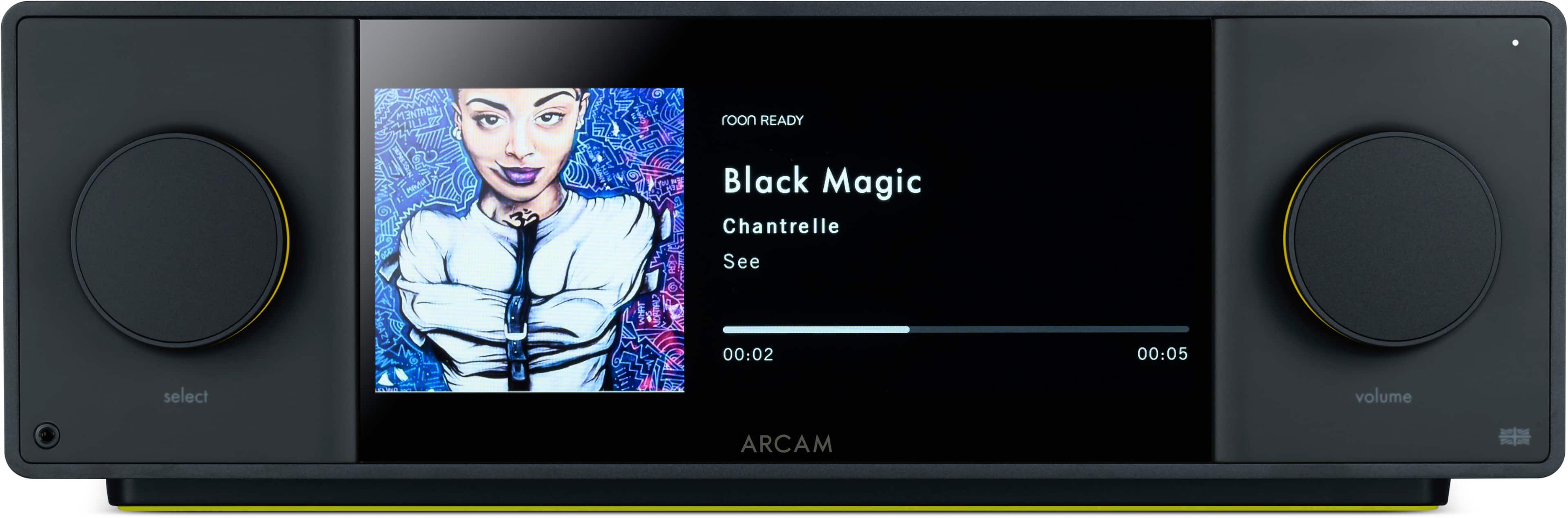 The text on the image reads: "Intety ILLV7 room READY N Black Magic Chantrelle See 00:02 00:05 select volume ARCAM." This text is grouped and corrected as follows:
"Intety ILLV7 room READY N Black Magic Chantrelle See 00:02 00:05 select volume ARCAM."
The corrected text is a description of the image, which features a woman on the screen of an ARCAM device. The device is set to play music, and the volume can be adjusted by using the buttons on the device.