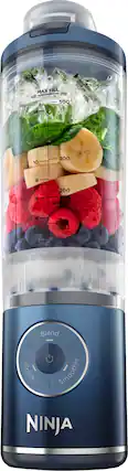 The image shows a Ninja blender filled with various fruits and vegetables, including bananas, strawberries, blueberries, and lettuce. The blender is designed to hold up to 500 ml of liquid, and the image emphasizes that it is a Ninja blender, which is known for its powerful blending capabilities. The blender is filled to the top with the assorted fruits and vegetables, indicating that it is ready for blending.