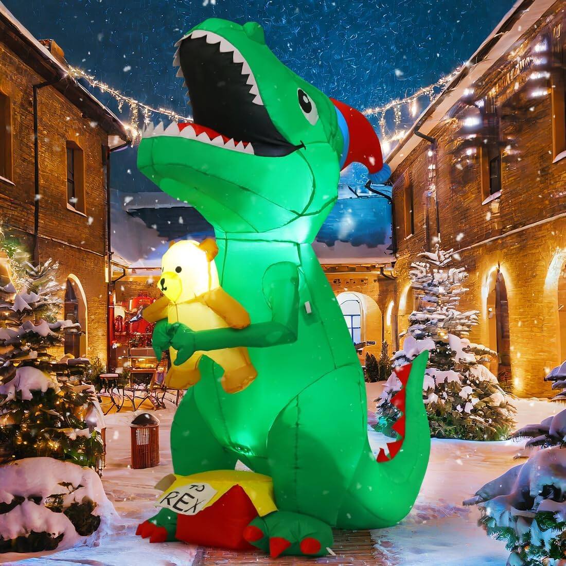 Angle. GOOSH Inflatables - GOOSH 7 FT Christmas Inflatables Dinosaur T Rex with Xmas Hat Holding a Bear with Built-in LEDs - Green.