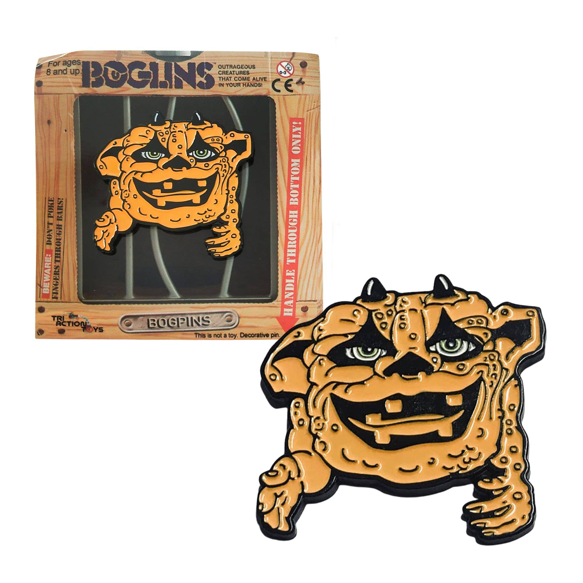 For ages 8 and up: BOGINS  
OUTRAGEOUS CREATURES THAT COME ALIVE IN YOUR HANDS!  

BEWARE: DON'T THROUGH FINGERS THROUGH THE BOTTOM HANDLE!  

TRI ACTION BOGINS  
This is not a toy. Decorative pin.