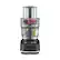 The image features a black and silver blender made by Breville. The blender is filled with various ingredients, including a cup and a spoon. The blender is designed to blend and mix ingredients together, making it a versatile appliance for preparing a variety of dishes and beverages.