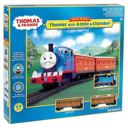 Sure, here is the corrected and grouped text from the image:
---
**THOMAS & FRIENDS**
**DELUXE**
**Thomas with Annie & Clarabel**
**HO SCALE ELECTRIC TRAIN**
- Complete and Ready-to-Run HO Scale Electric Train Set with Snap-Fit E-Z Track
- Thomas' Eyes Move side to side!
- 36" Circle of Snap-Fit E-Z Track
- 17 Pieces
**Thomas the Tank Engine** with moving eyes
**Annie coach**
**Clarabel Coach**
**BACHMANN**
---
**8+**
**CHOKING HAZARD - Small parts. Not for children under 3 years.**
**ELECTRICALLY OPERATED PRODUCT**
**17 Pieces**
**Thomas' Eyes Move side to side!**
**36" Circle of Snap-Fit E-Z Track**