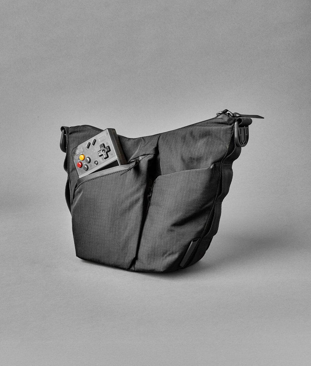 Alt View 2. ALPAKA - Flow Satchel Mini 2L Crossbody Bag, Water Resistant Shoulder Bag, Expandable Bottle Pocket, YKK Zippers - Black Axoflux 210D.